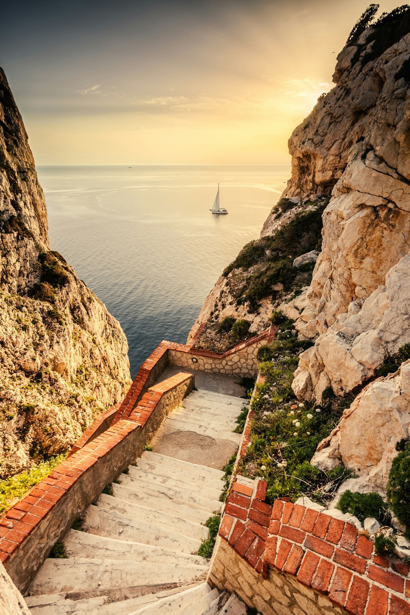 Stone steps leading down to Sardinian coastal cliffs