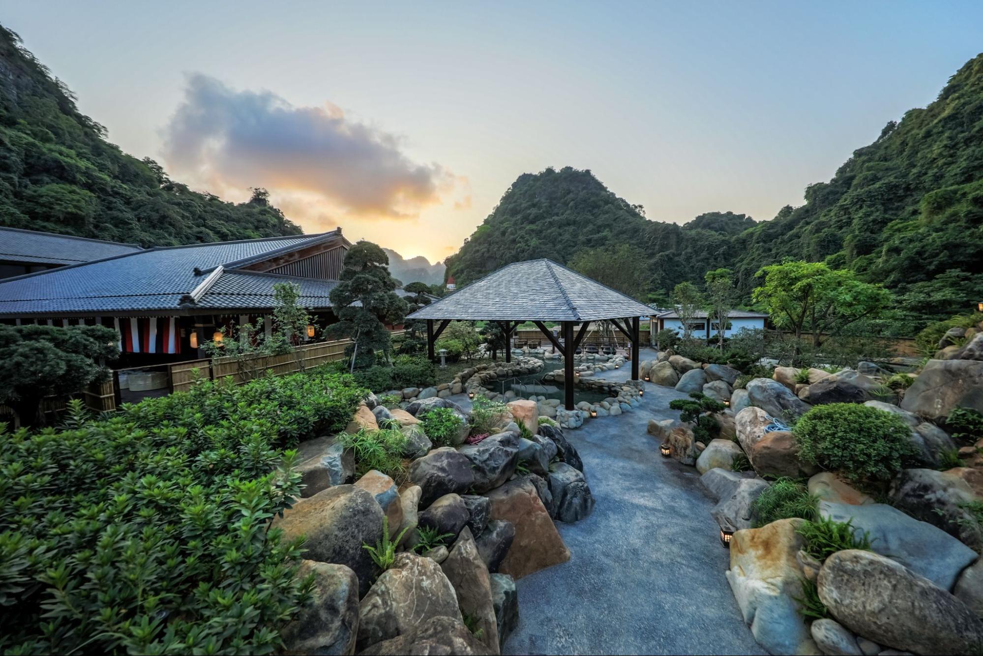 Garden pathways and outdoor onsen areas in Quang Hanh valley resort