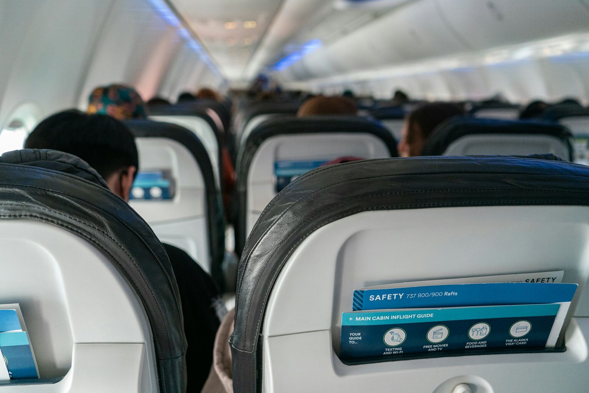 Passengers seated inside short-haul aircraft cabin