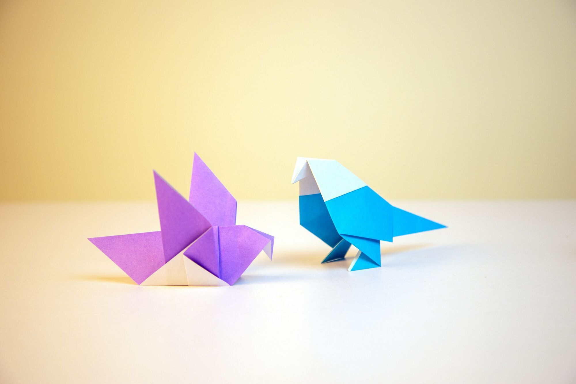 Colourful origami figures displayed on a light background