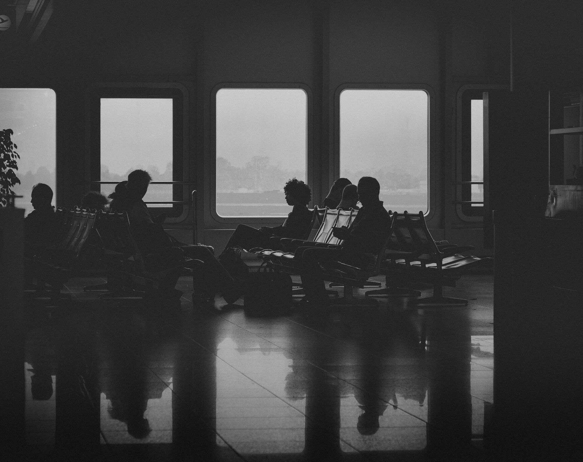 Travellers waiting indoors during bad weather