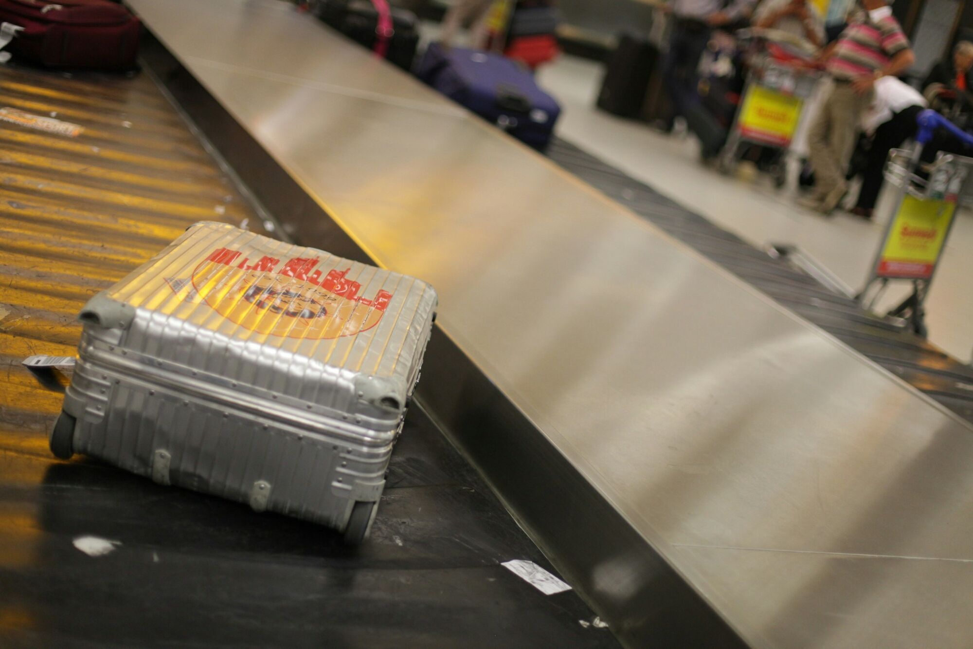 Suitcase circulating on airport baggage claim conveyor belt