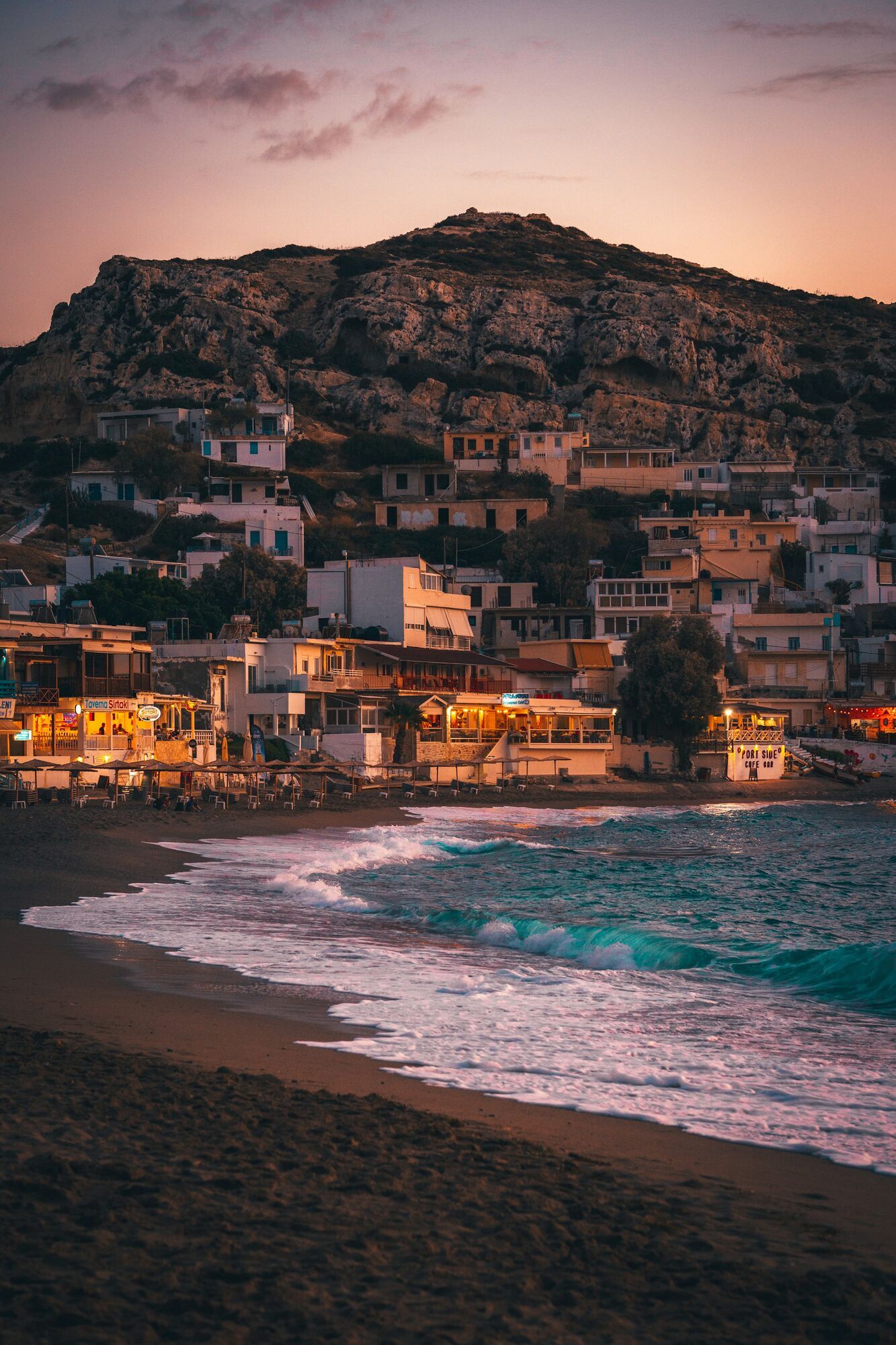 Crete seaside village and beach at sunset