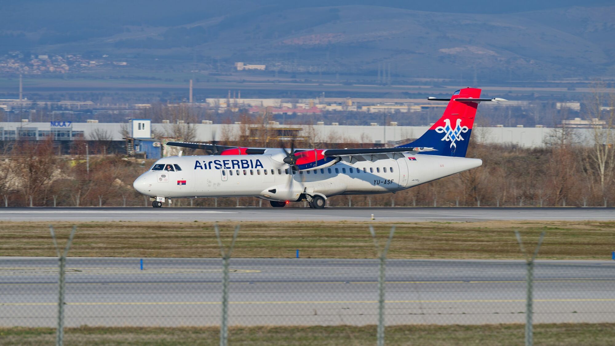 Air Serbia turboprop aircraft on runway at airport