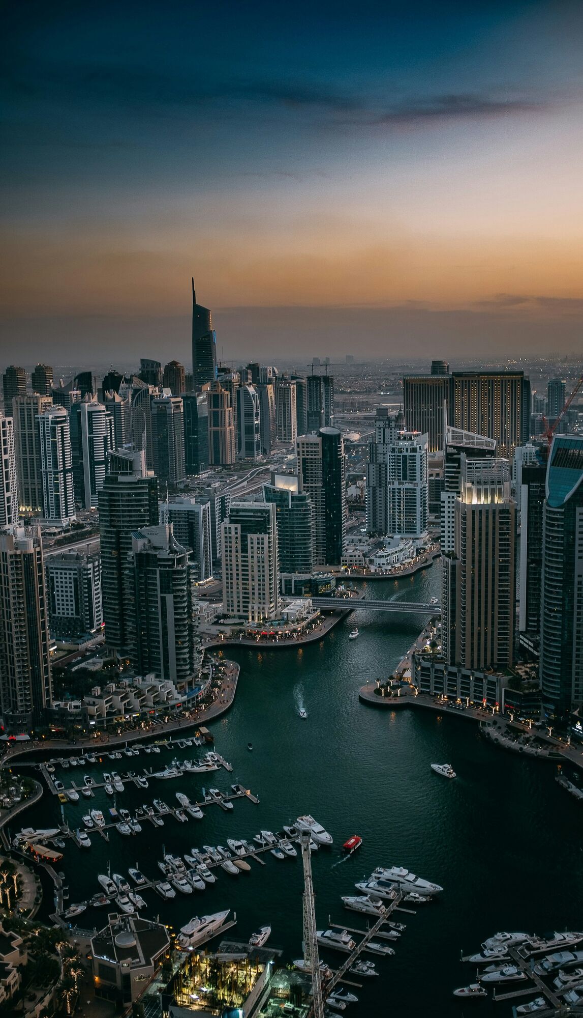 Dubai Marina skyline with high-rise buildings and waterfront at sunset