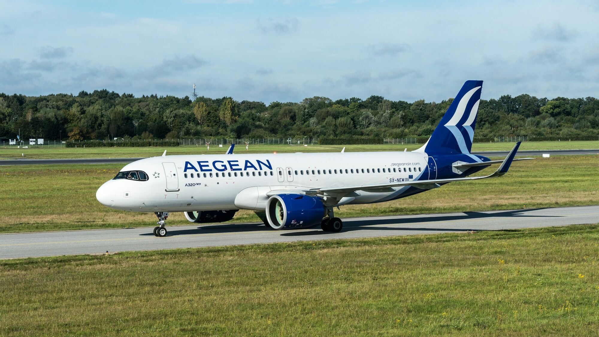 Aegean Airlines aircraft taxiing on runway during daylight