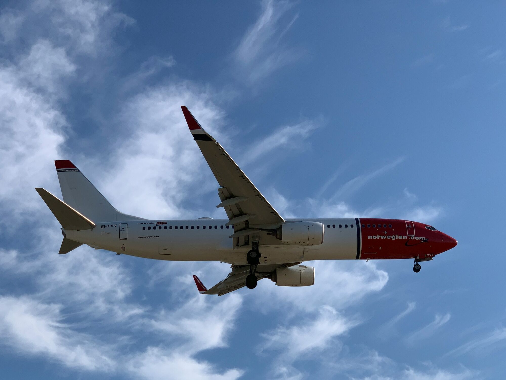 Norwegian aircraft in flight against clear sky