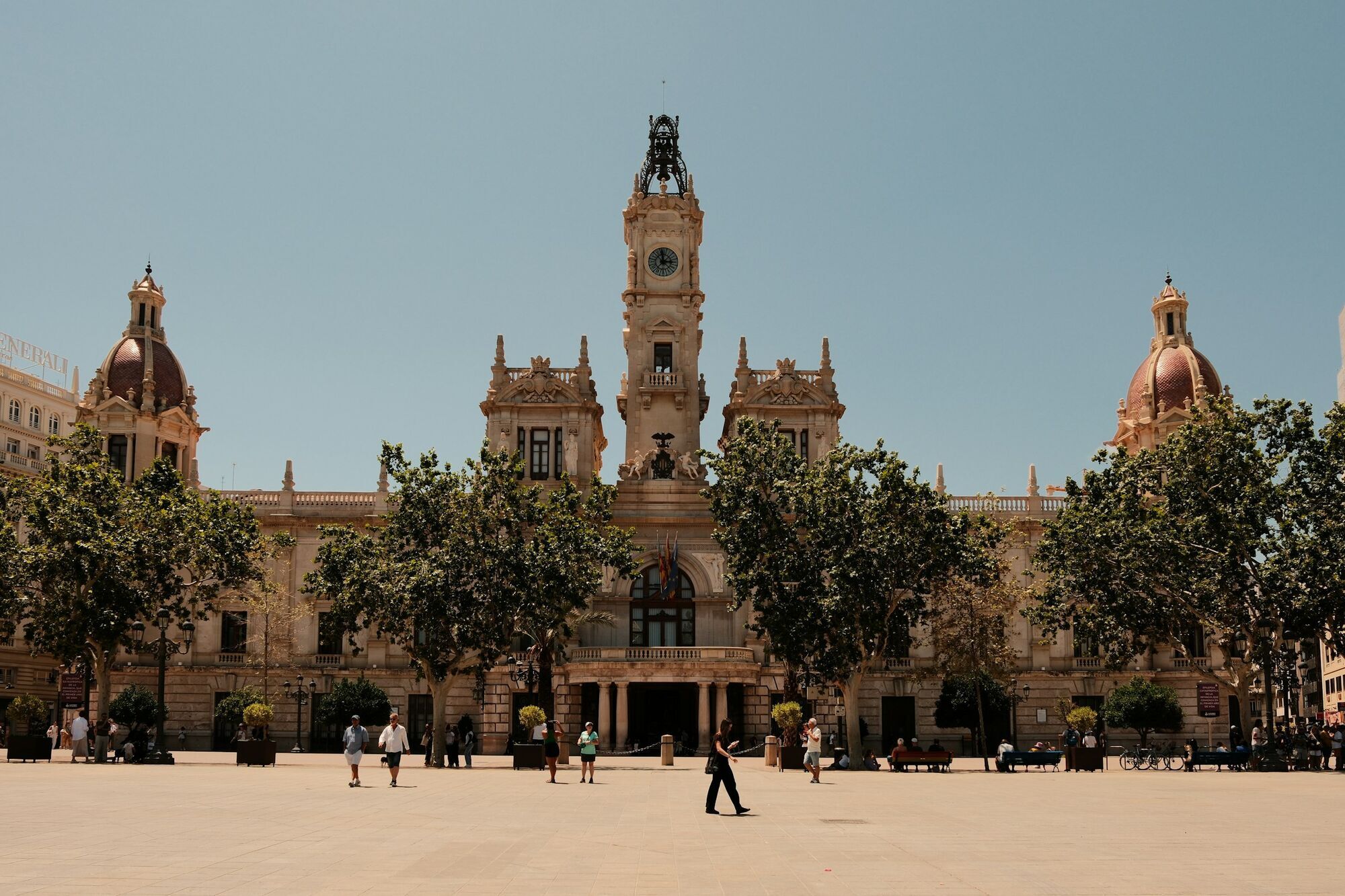 Historic city square in Spain with landmark building and tourists