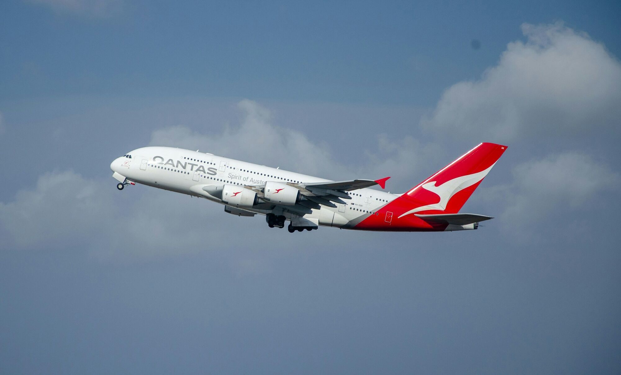 Qantas aircraft flying in cloudy sky