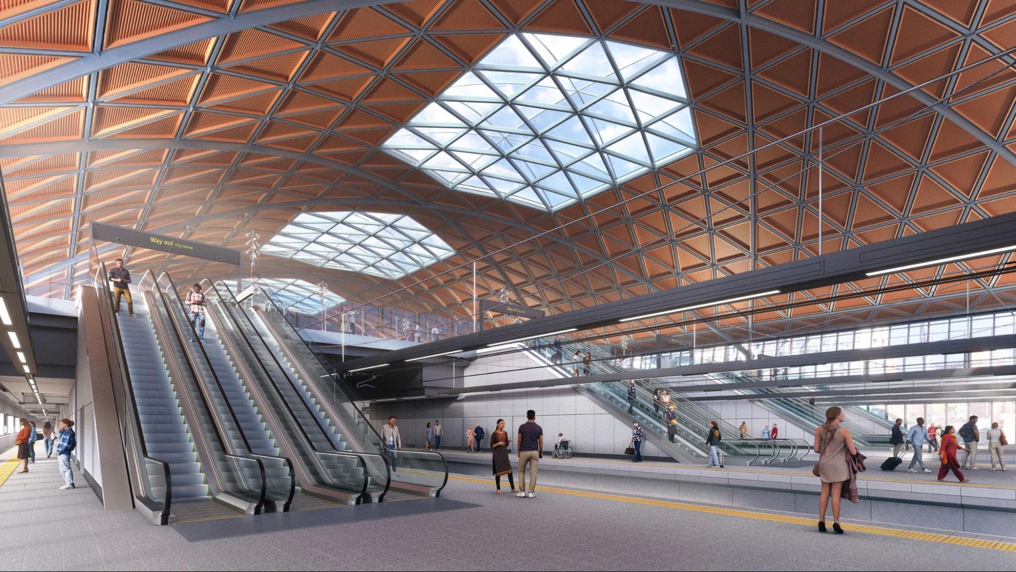 Interior view of Birmingham Curzon Street HS2 station with escalators and curved roof design