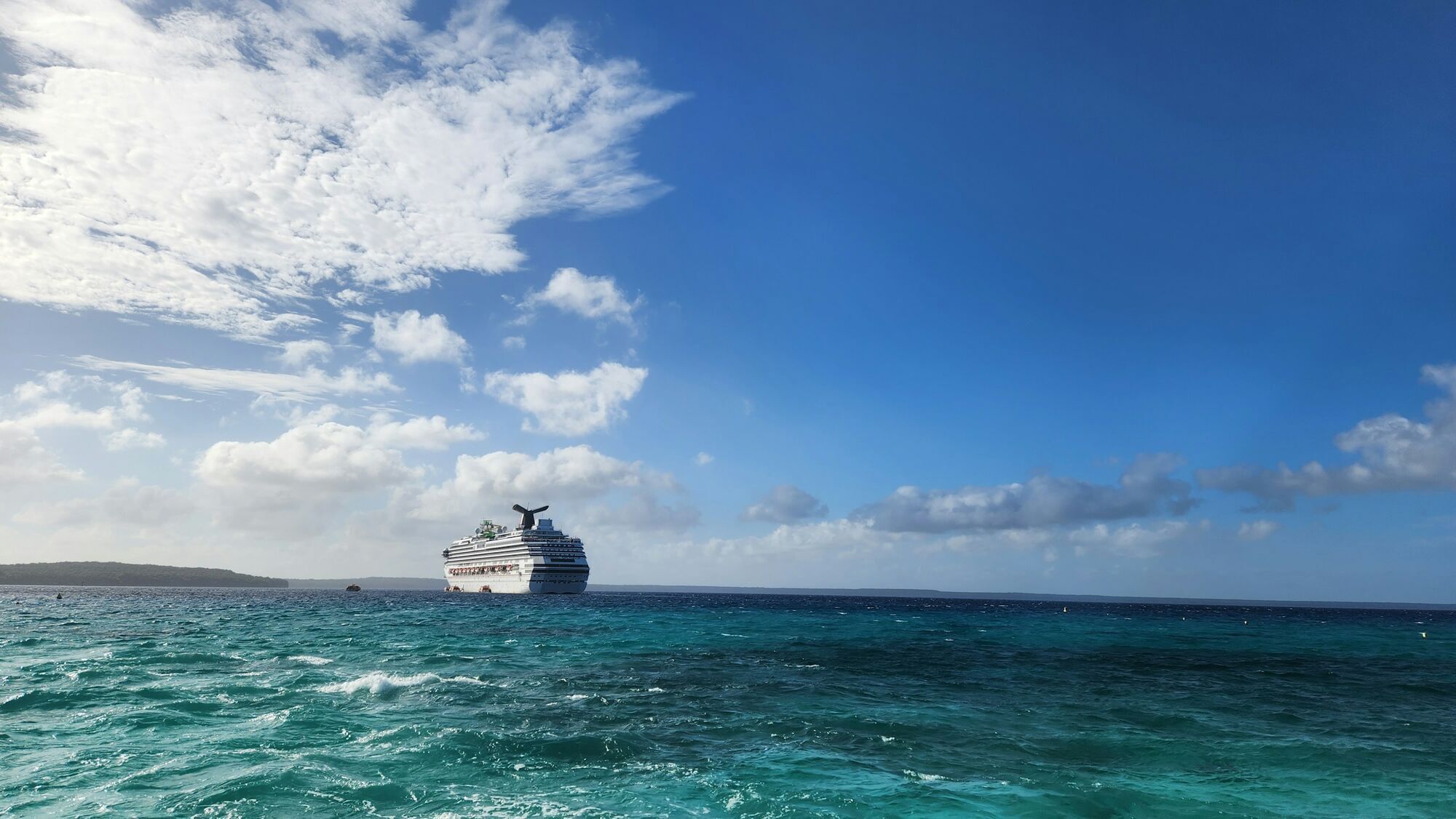 Cruise ship sailing in clear blue waters