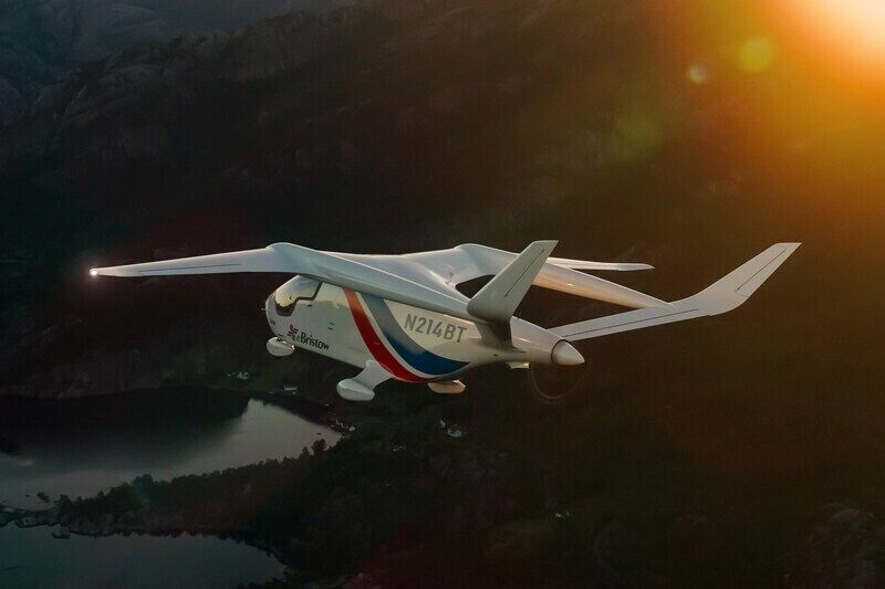 Electric aircraft flying above mountainous landscape