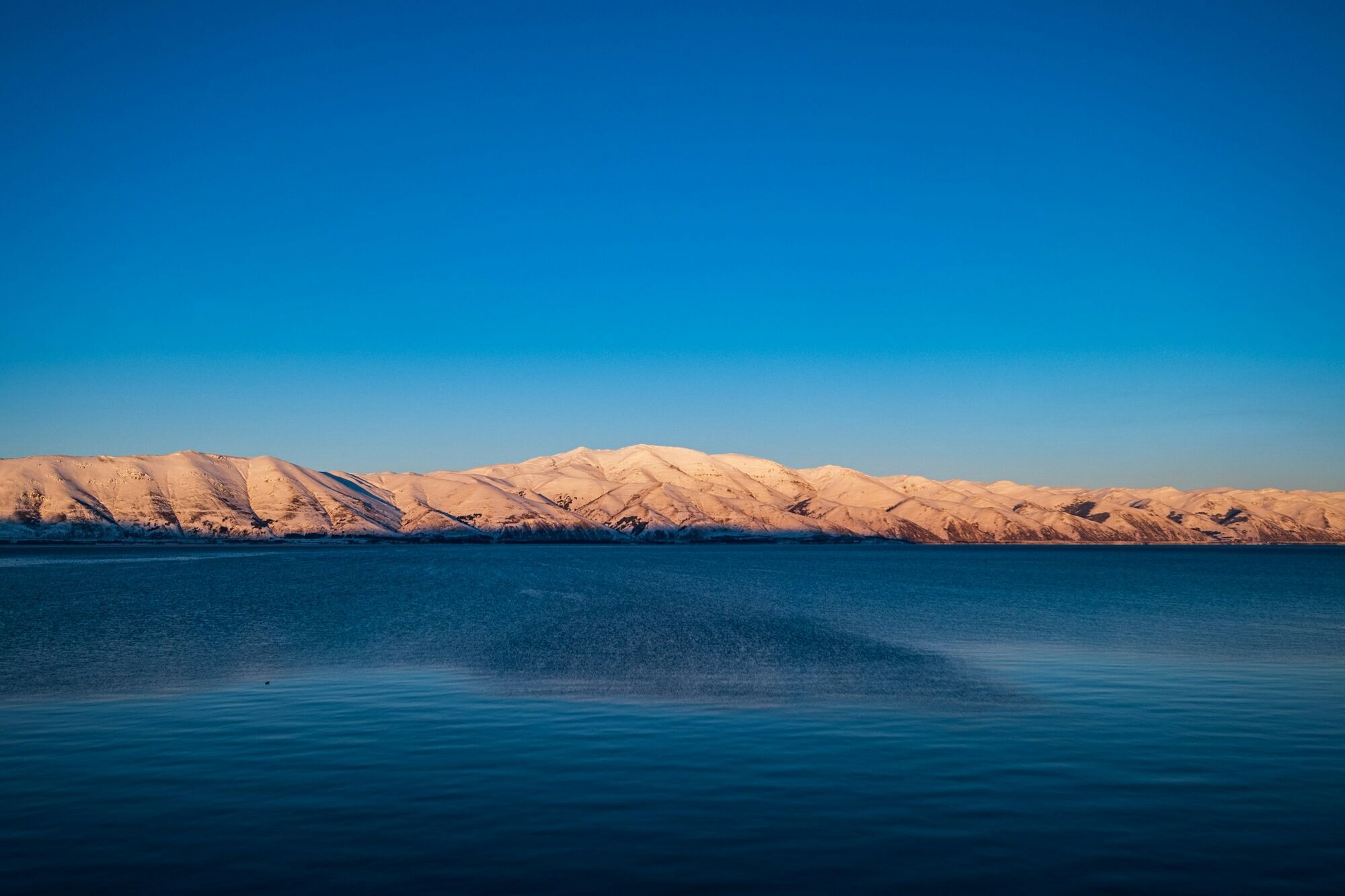 Lake Sevan with snow-covered mountains