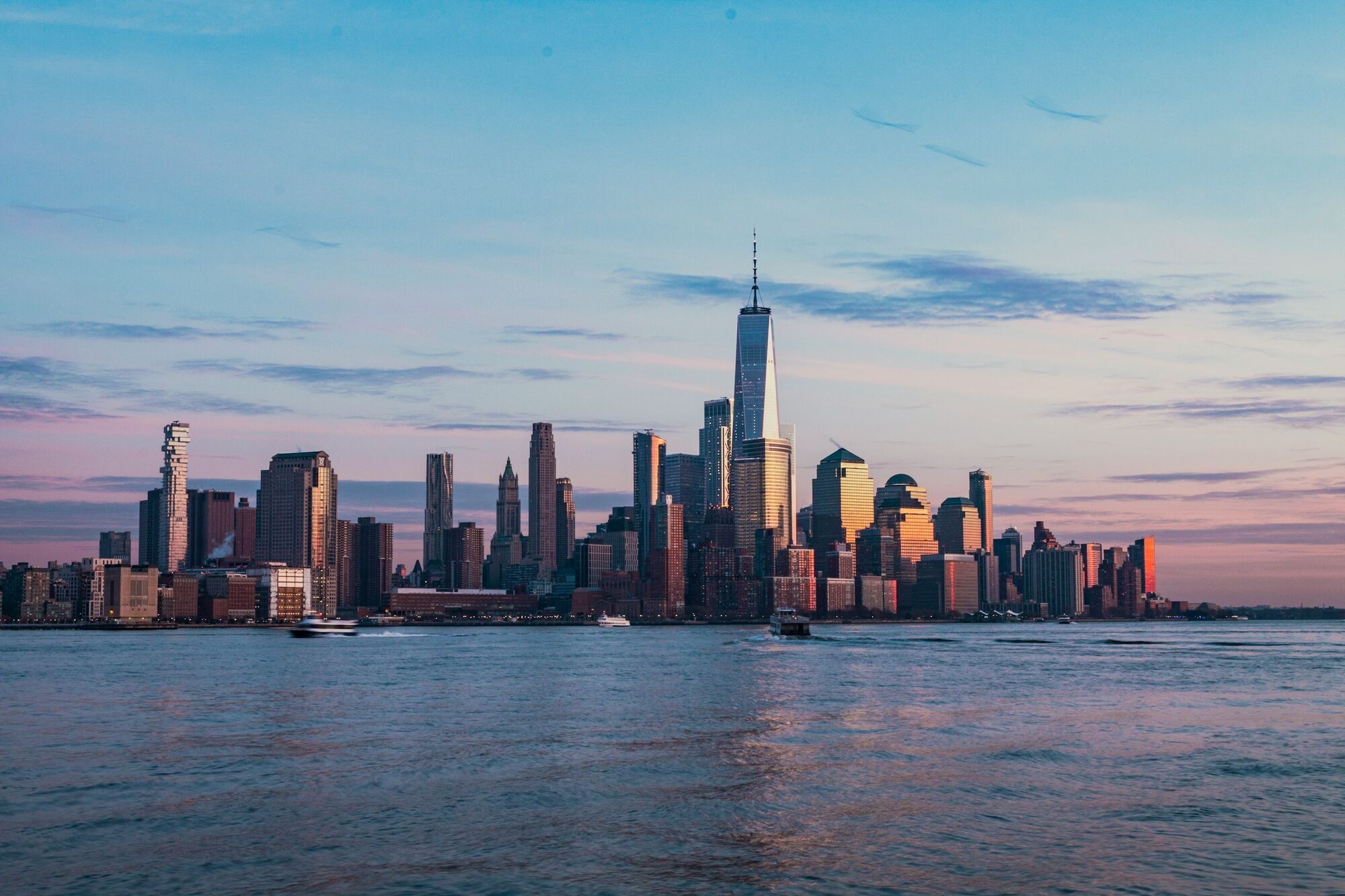 Lower Manhattan skyline at sunset with One World Trade Center