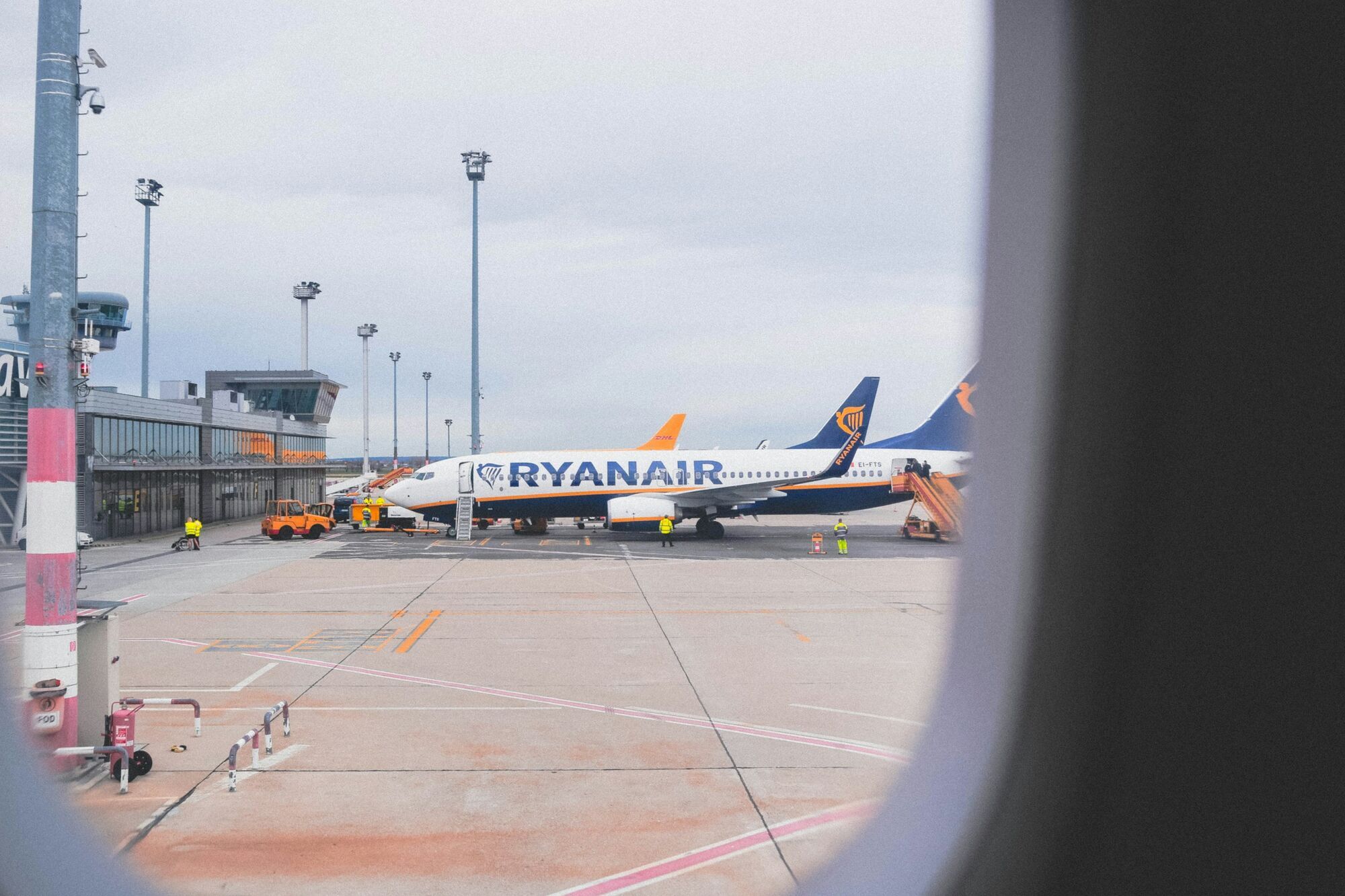 Ryanair aircraft parked at airport gate during ground handling