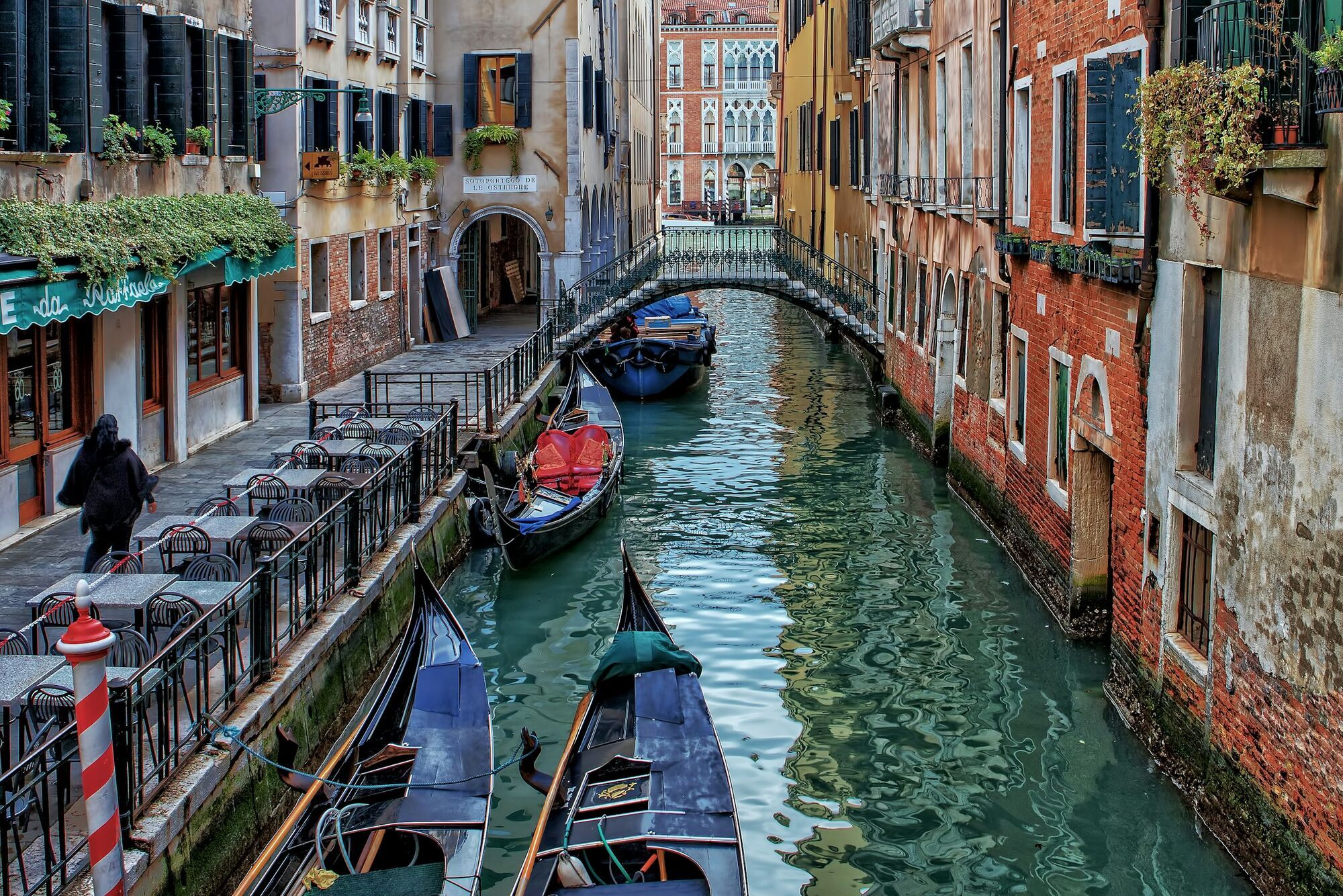 Gondolas on a quiet Venice canal between historic buildings