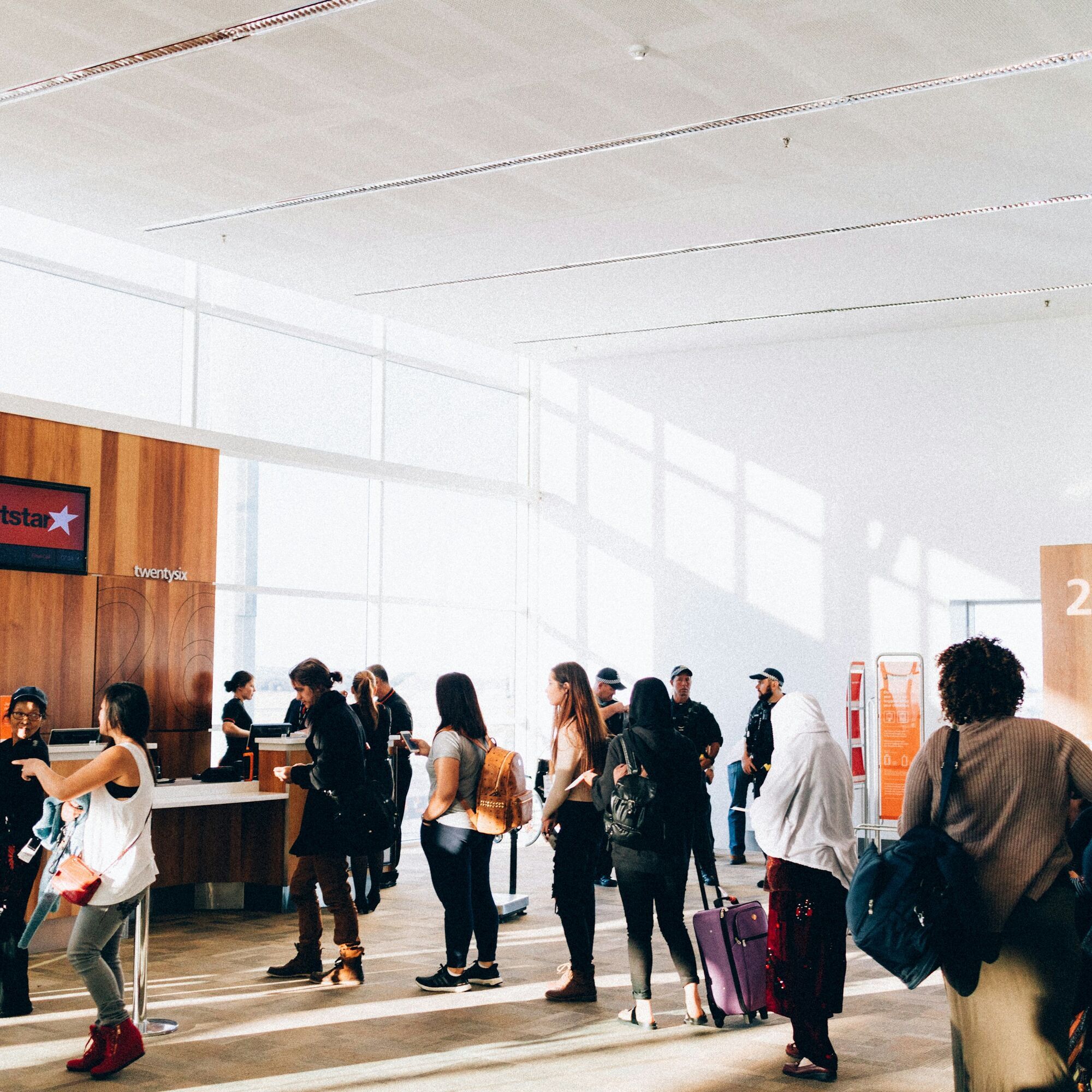 Passengers queueing at airport check-in counters