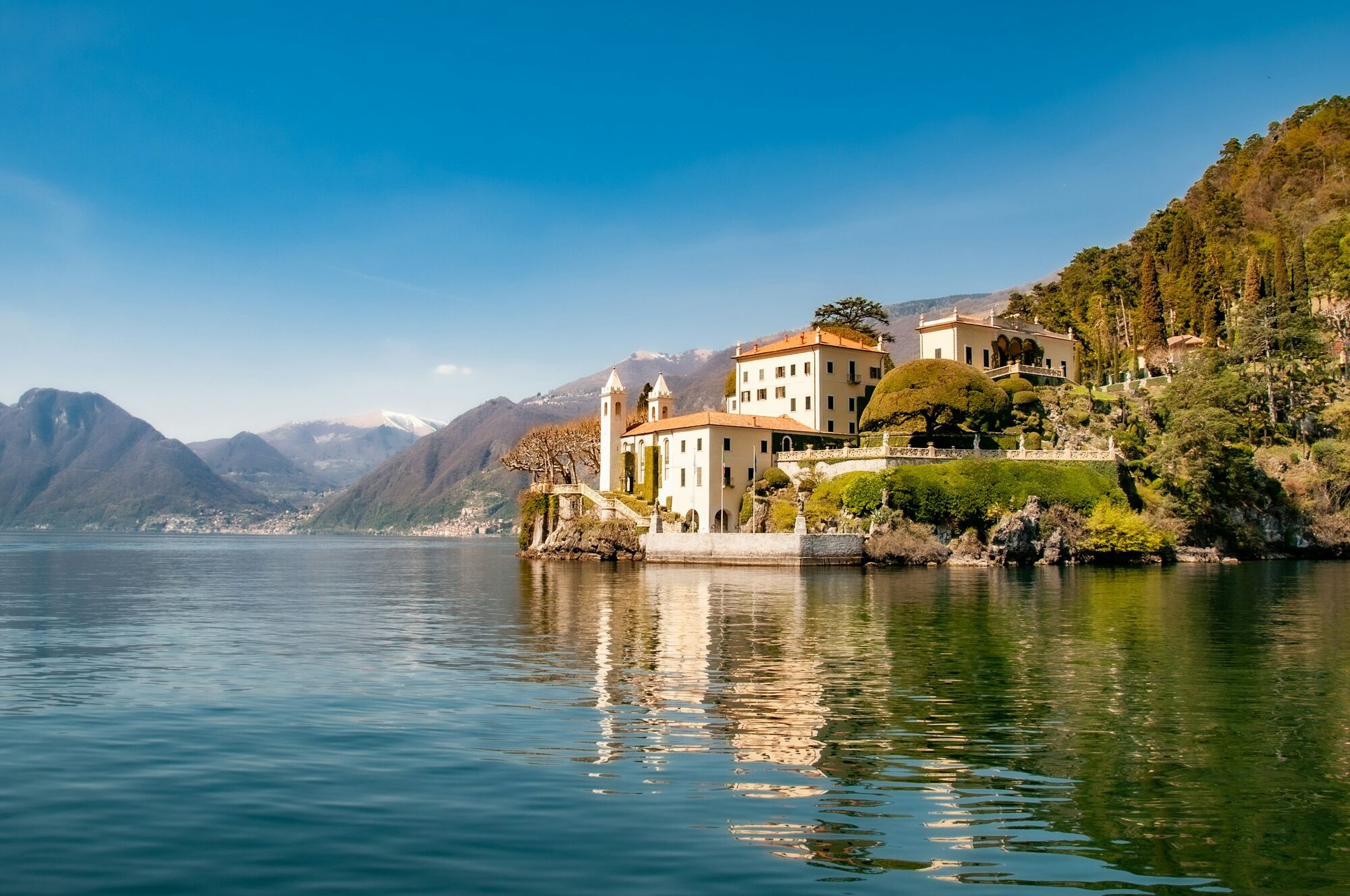 Lake Como shoreline with historic villa and mountains