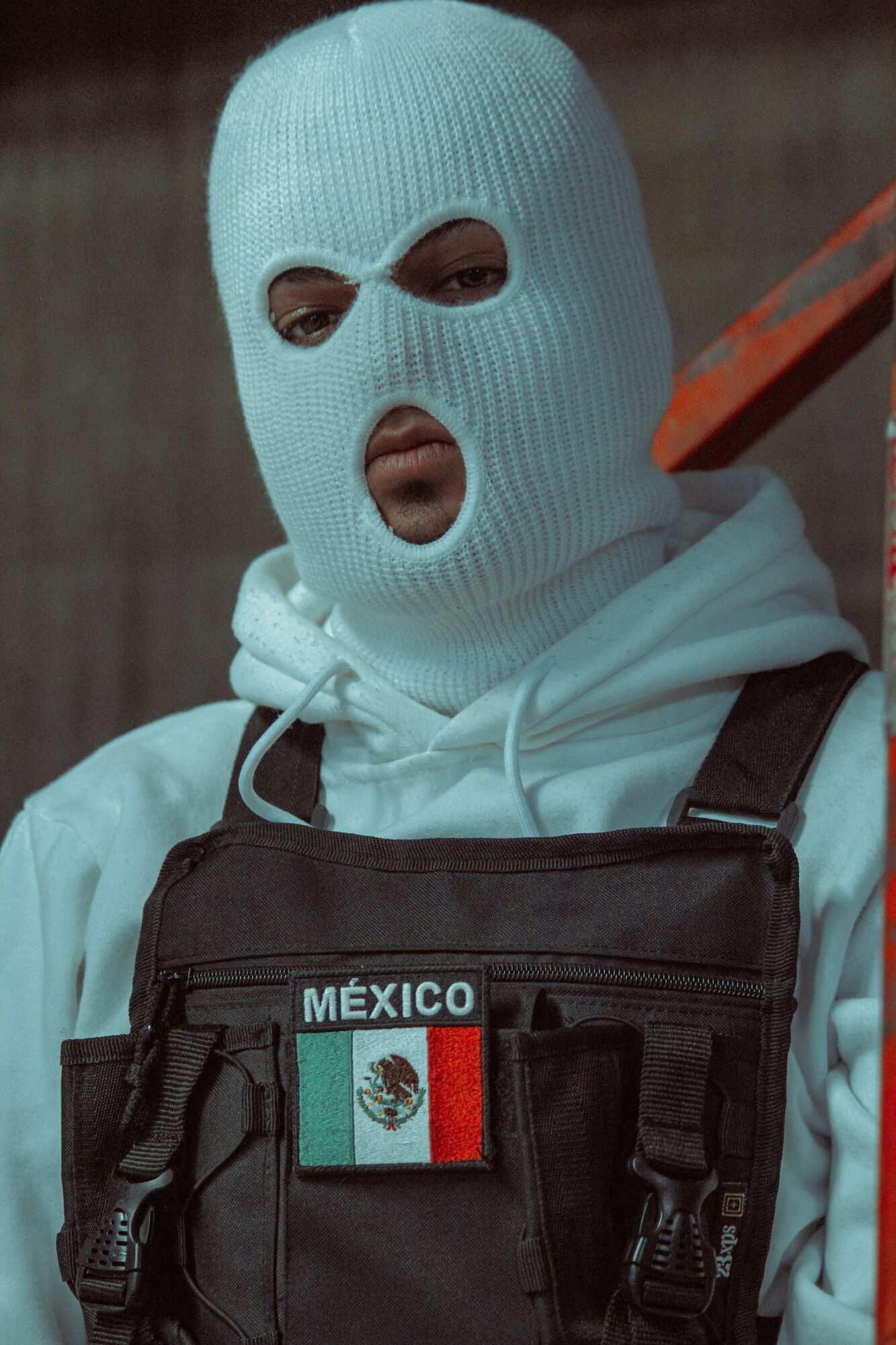 Person wearing mask and vest with Mexico flag