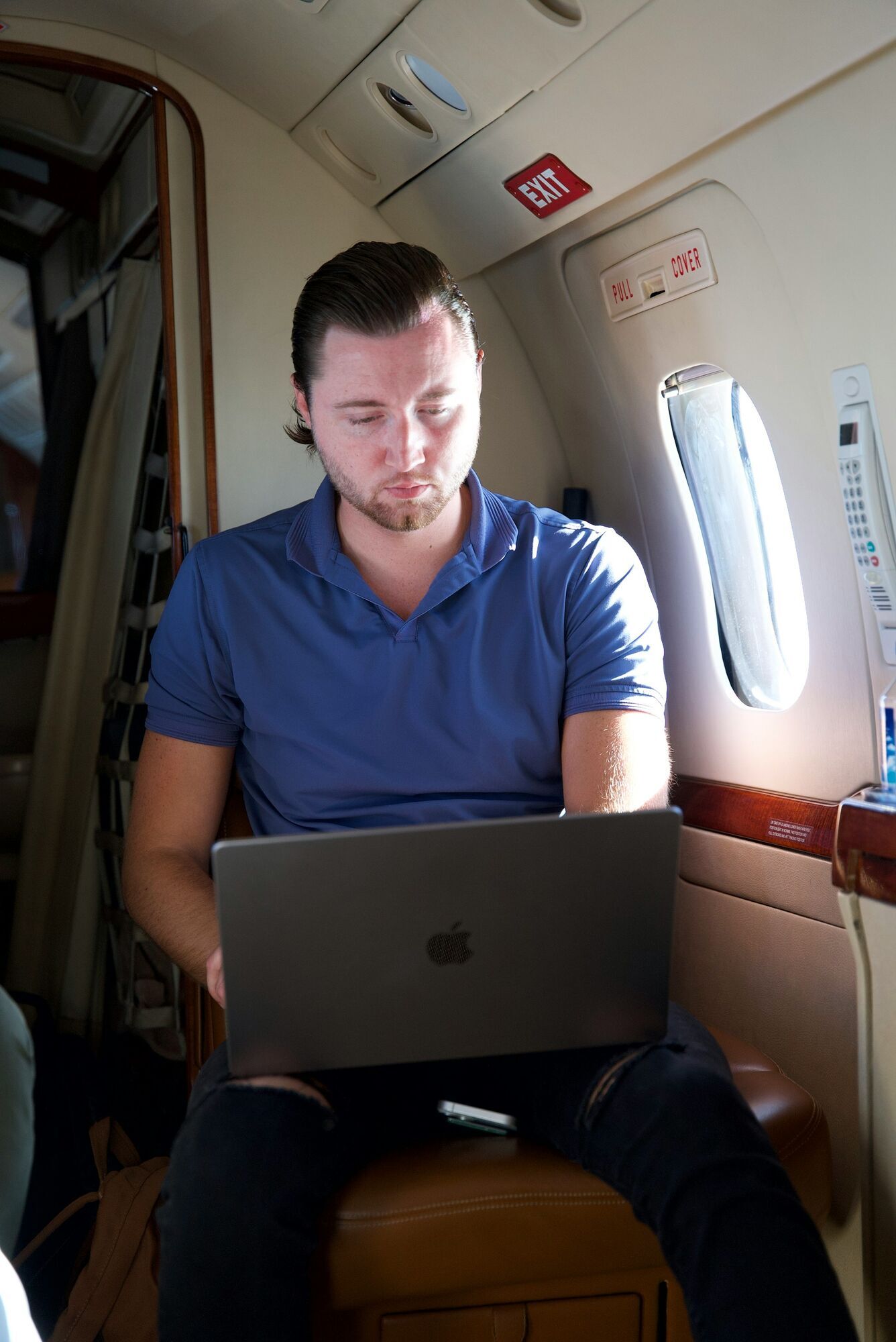 Passenger using laptop inside aircraft cabin