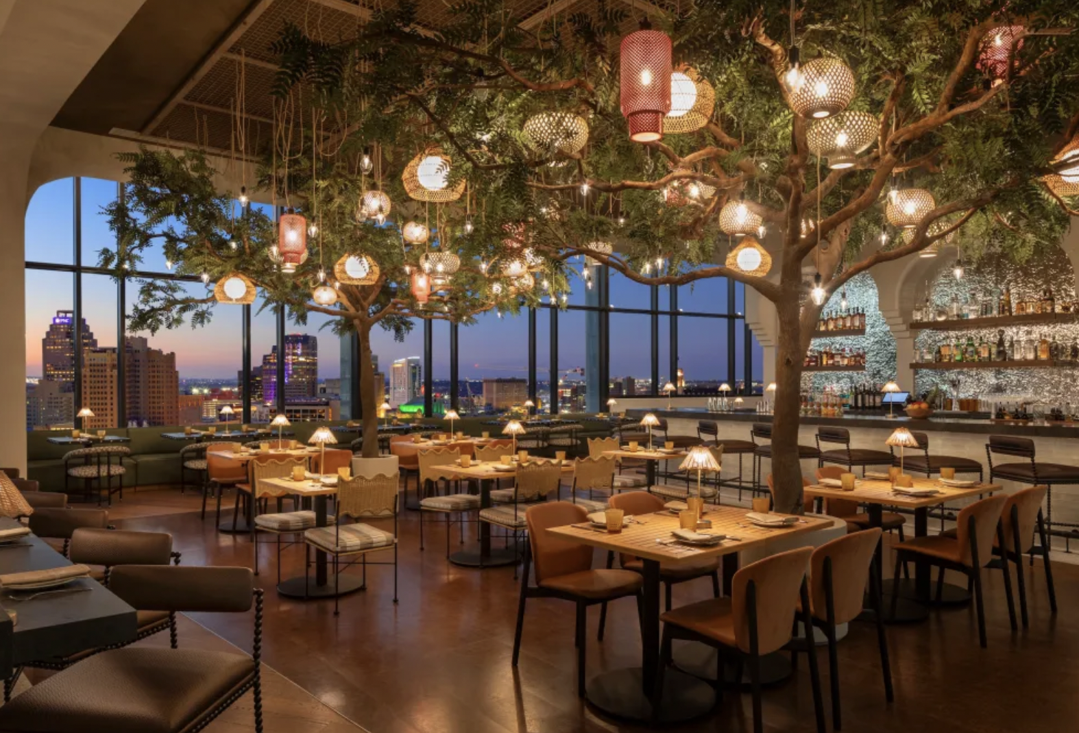 Rooftop restaurant interior overlooking San Antonio skyline
