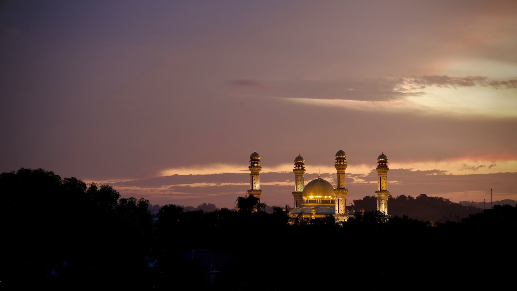 Mosque skyline in Brunei at sunset with golden domes
