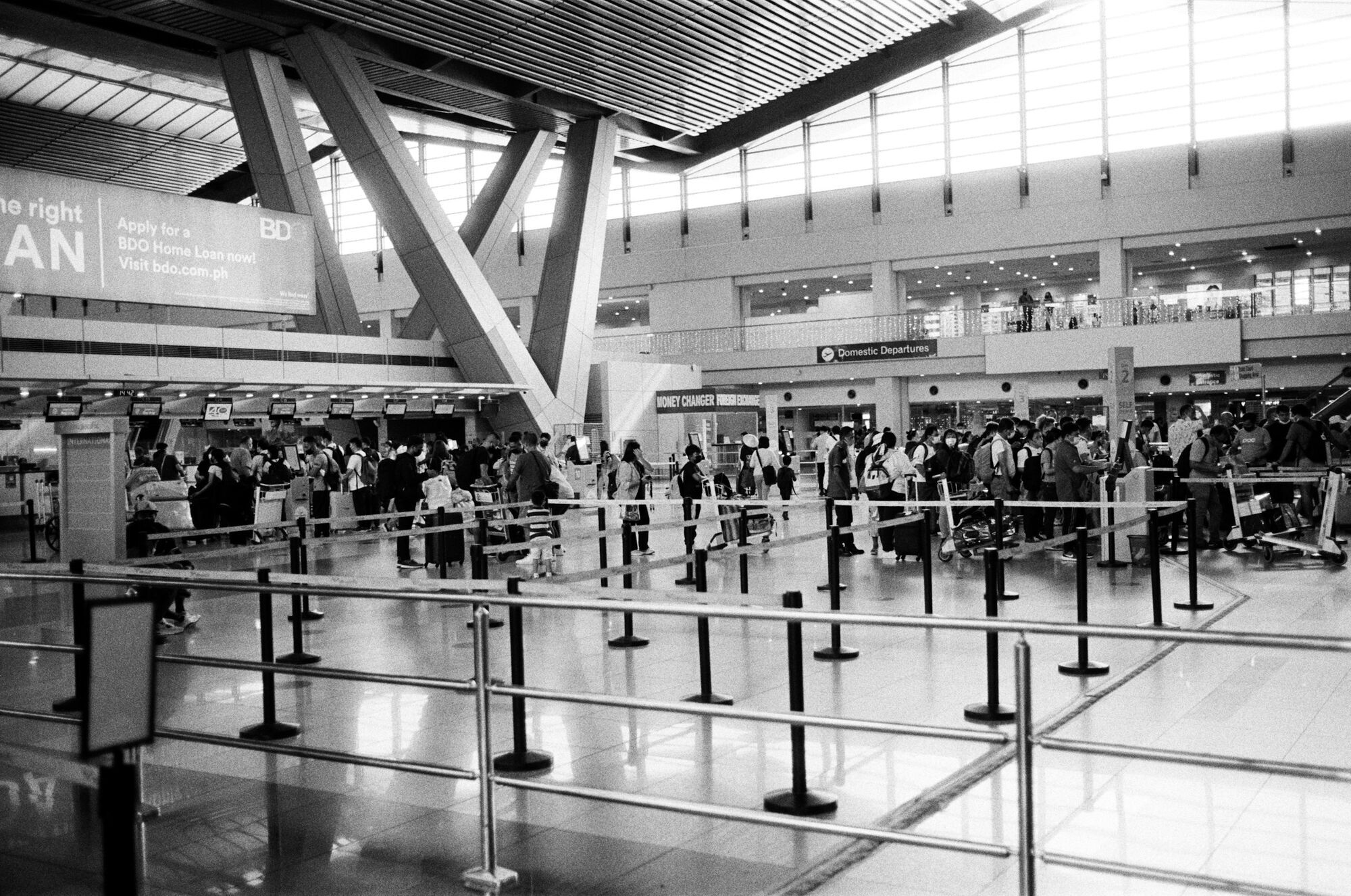 Travellers waiting in line at airport border control area