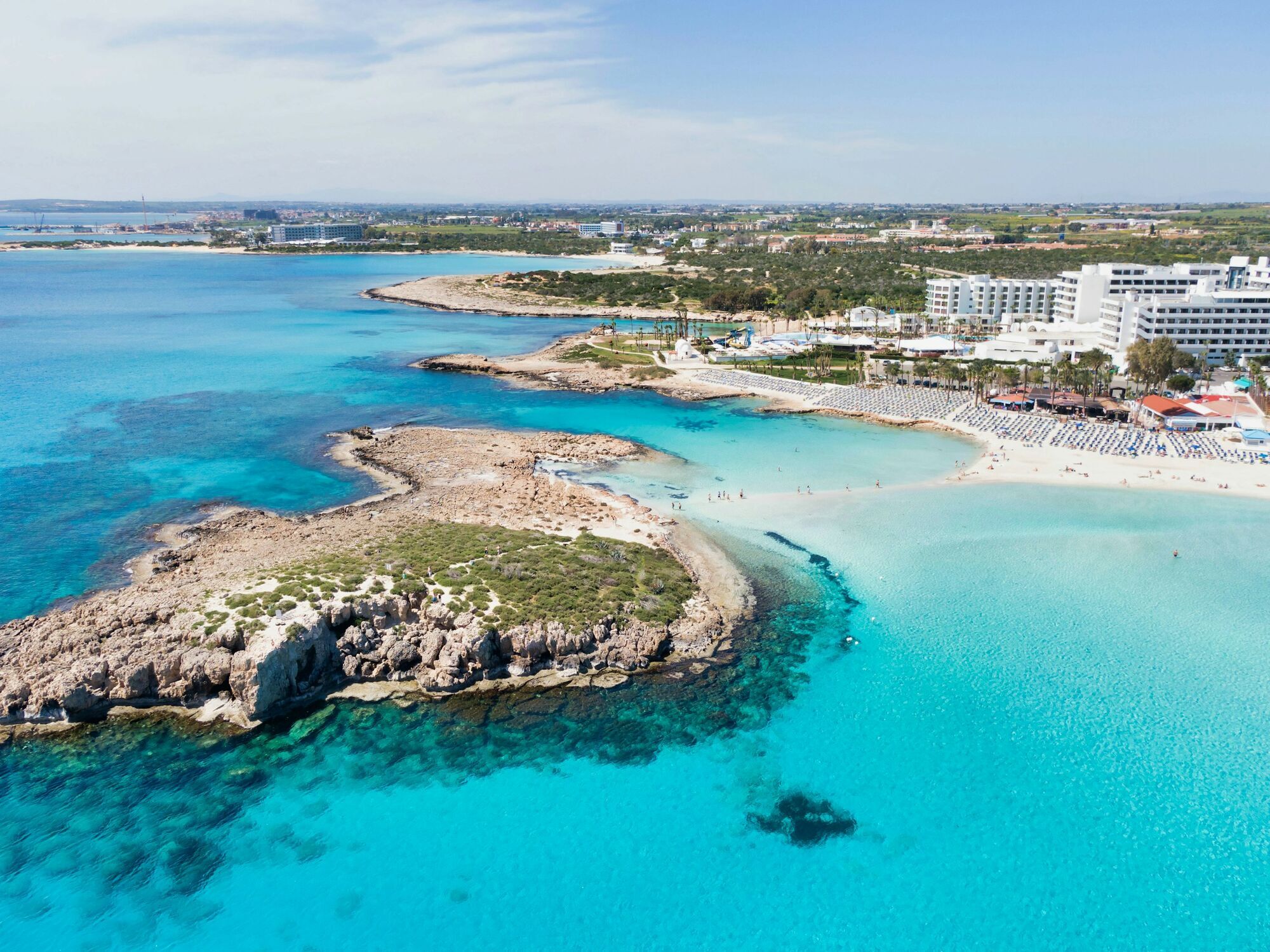 Aerial view of Cyprus coastline with turquoise water and beach resorts