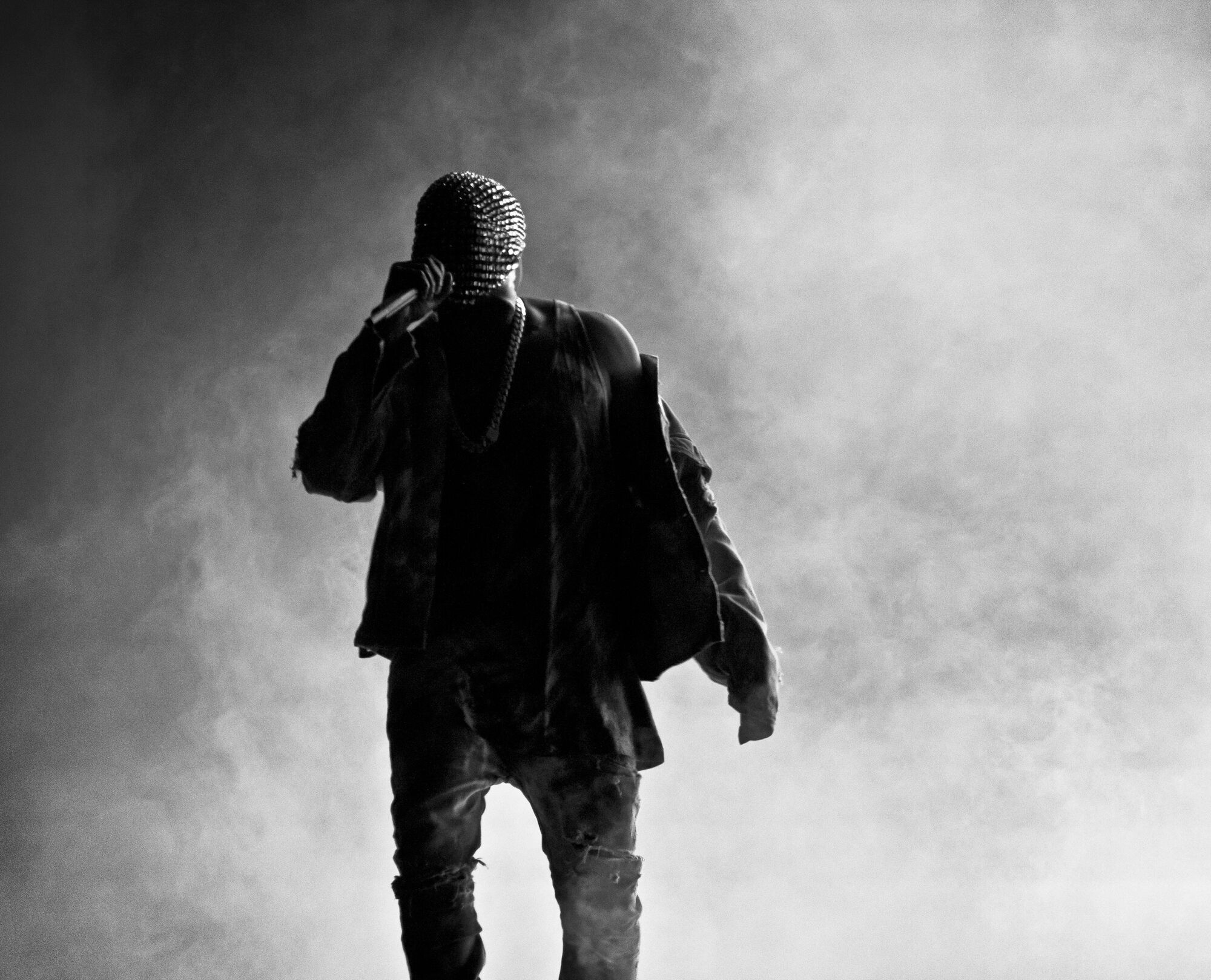 Kanye West performing under stage lights