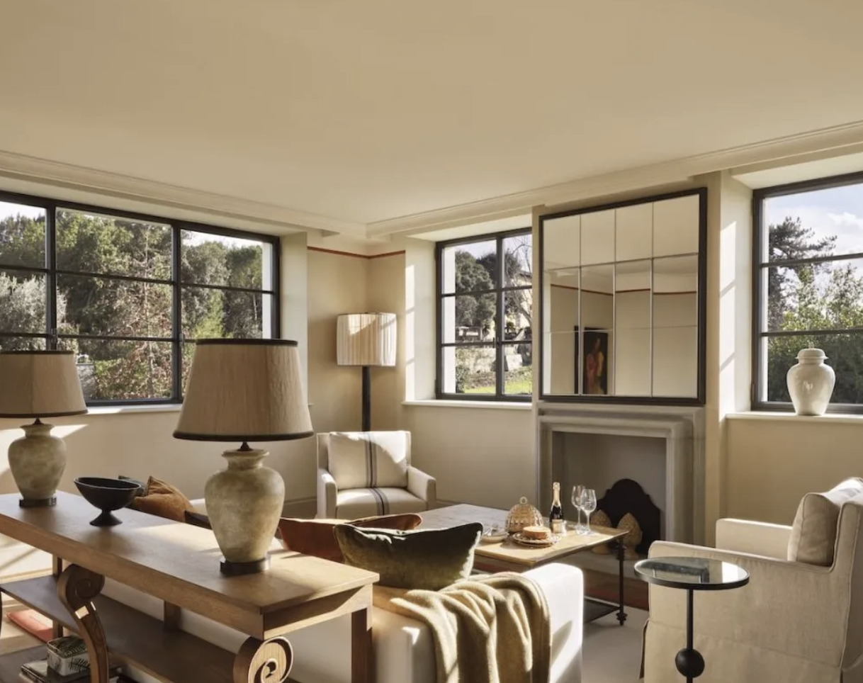 Elegant hotel suite with fireplace and large windows