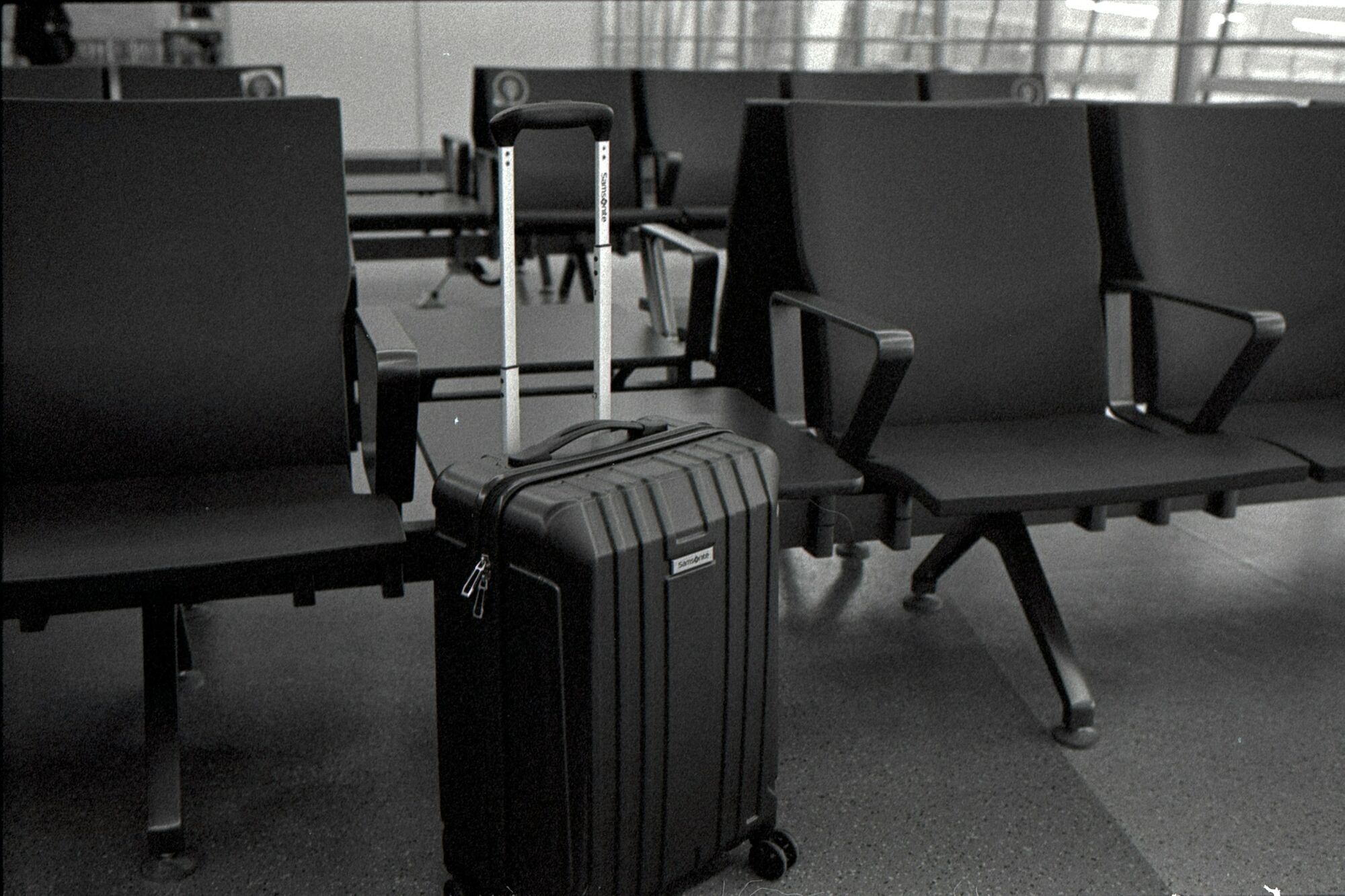 Carry-on suitcase in airport waiting area