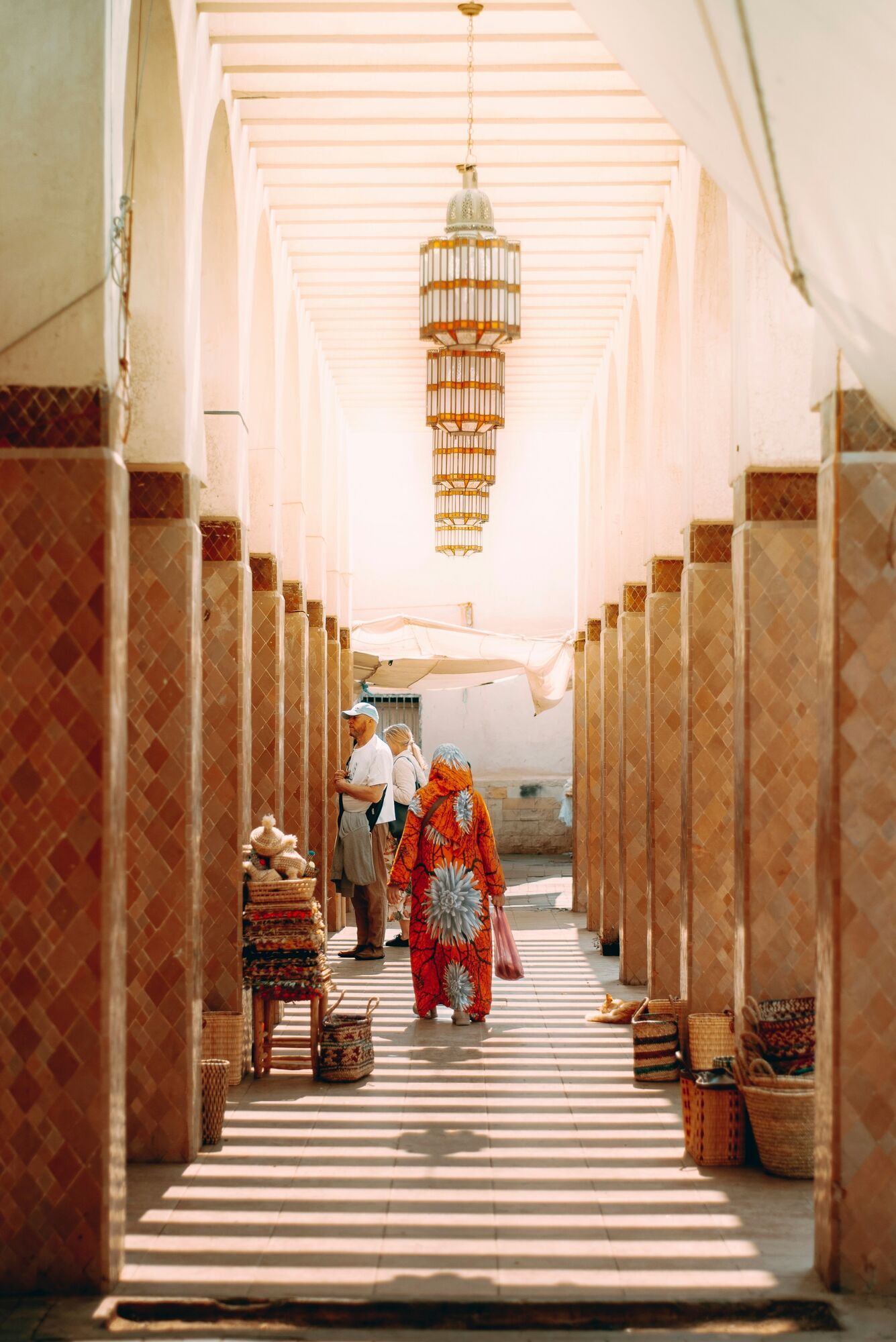 Traditional Moroccan corridor with arches and local visitors