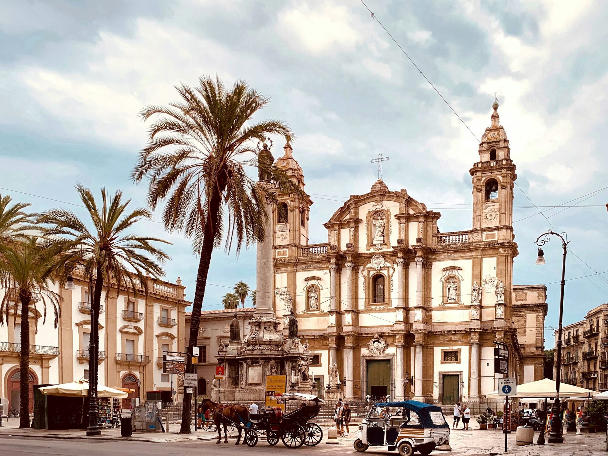 Palermo historic square with baroque church and palm trees