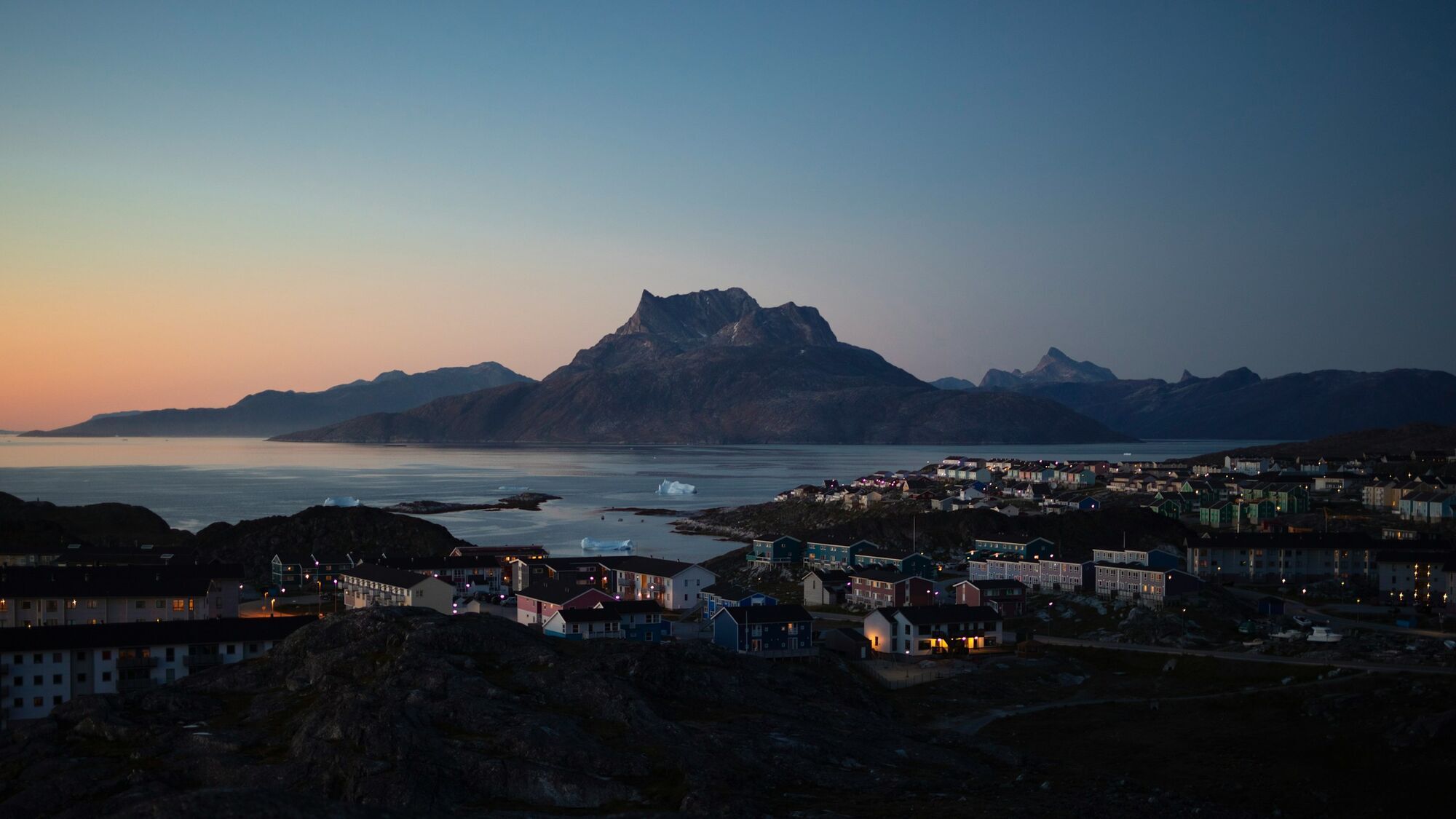 Nuuk coastal town with mountains and sea at dusk