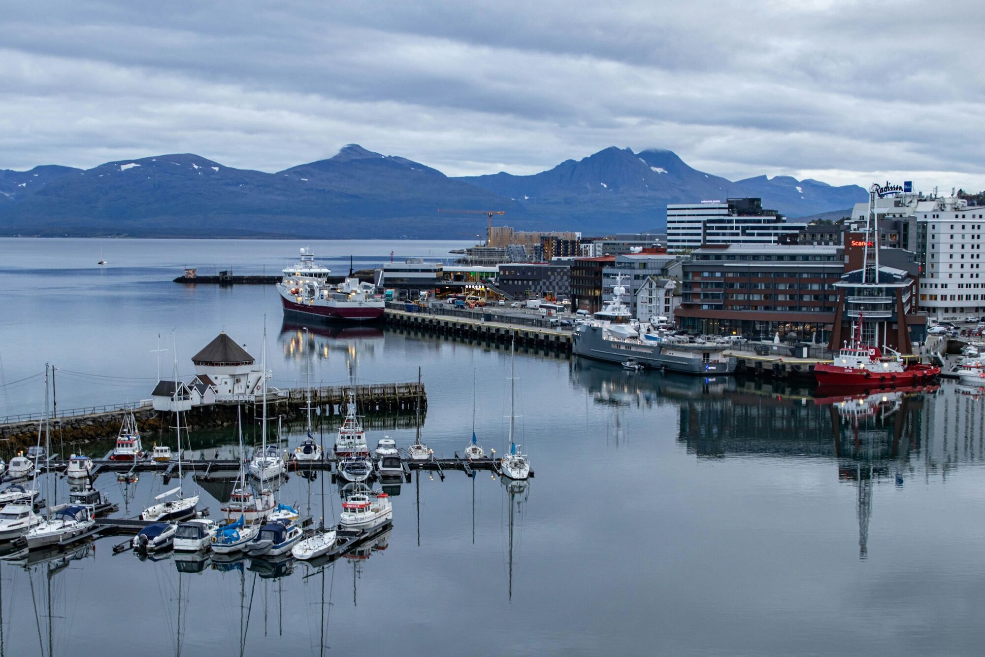 Harbour in Svolvær with boats and surrounding mountains