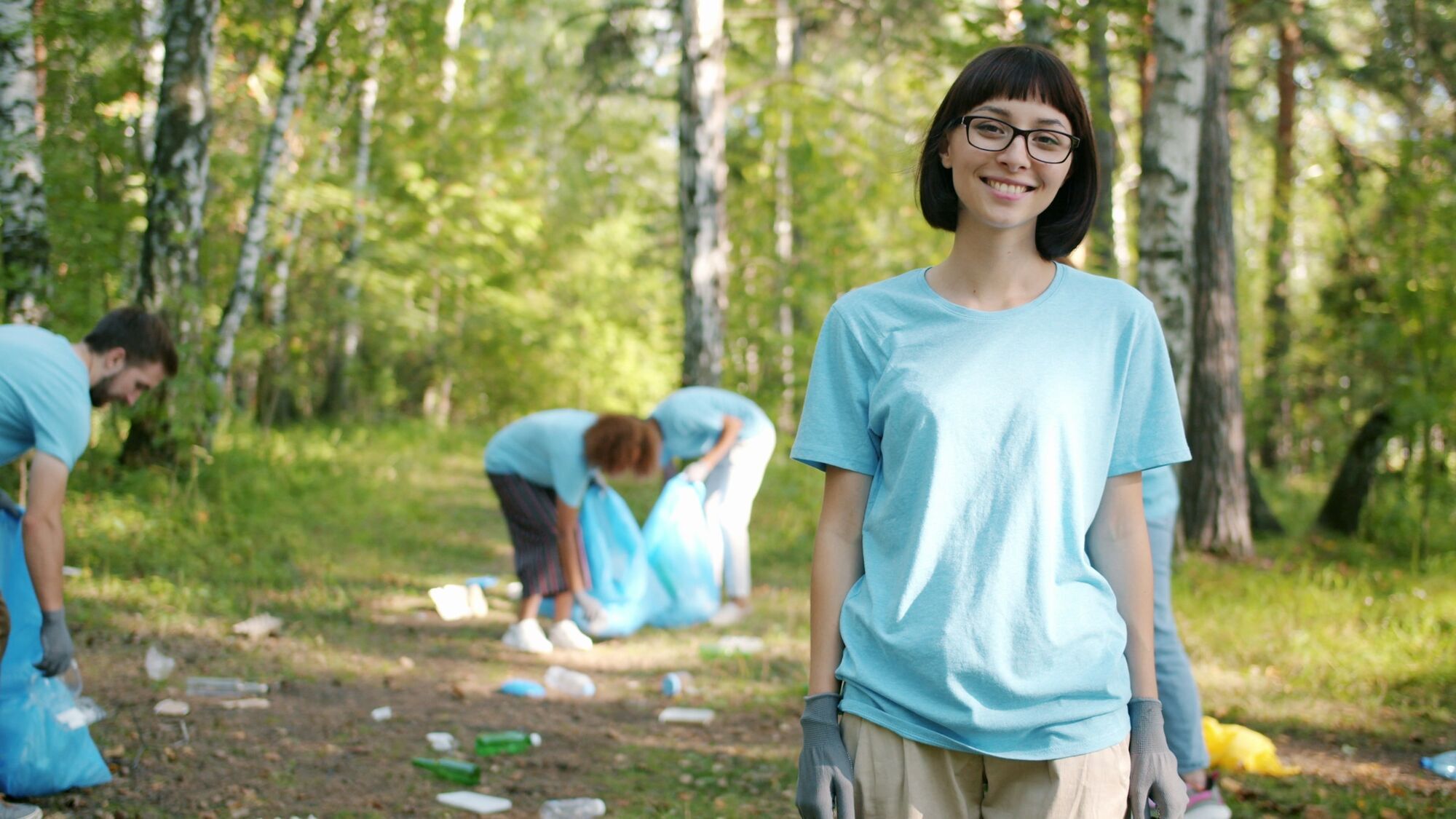 Volunteers collecting rubbish in green park area