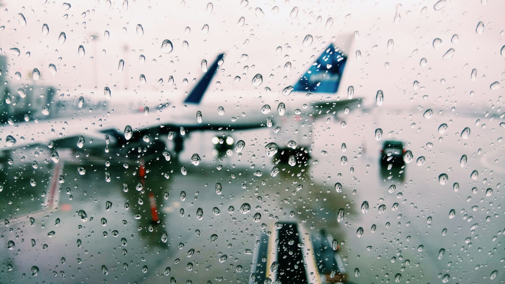Raindrops on aircraft window during bad weather
