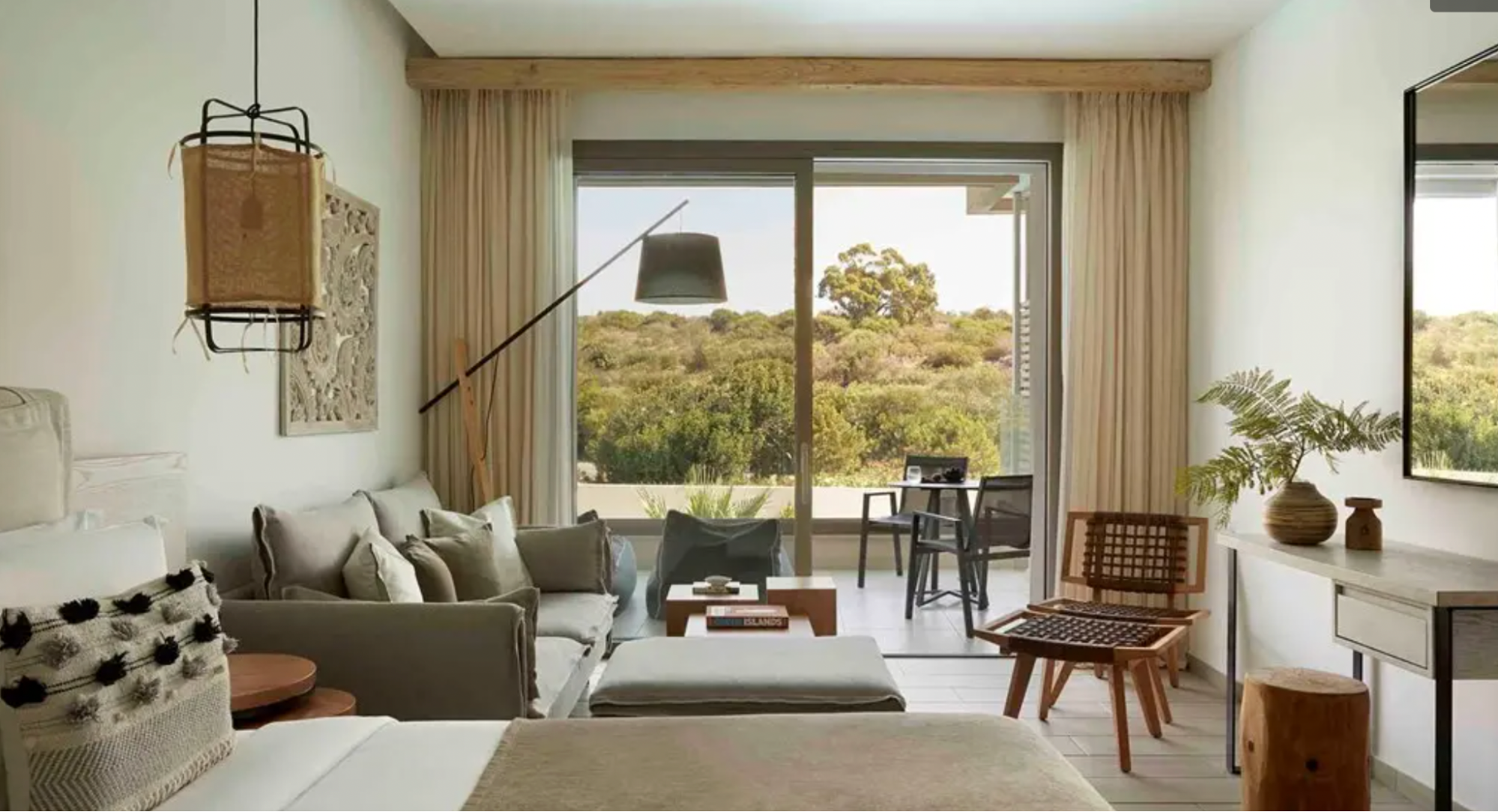 Modern room with terrace overlooking greenery at Mare Ayia Napa resort in Cyprus