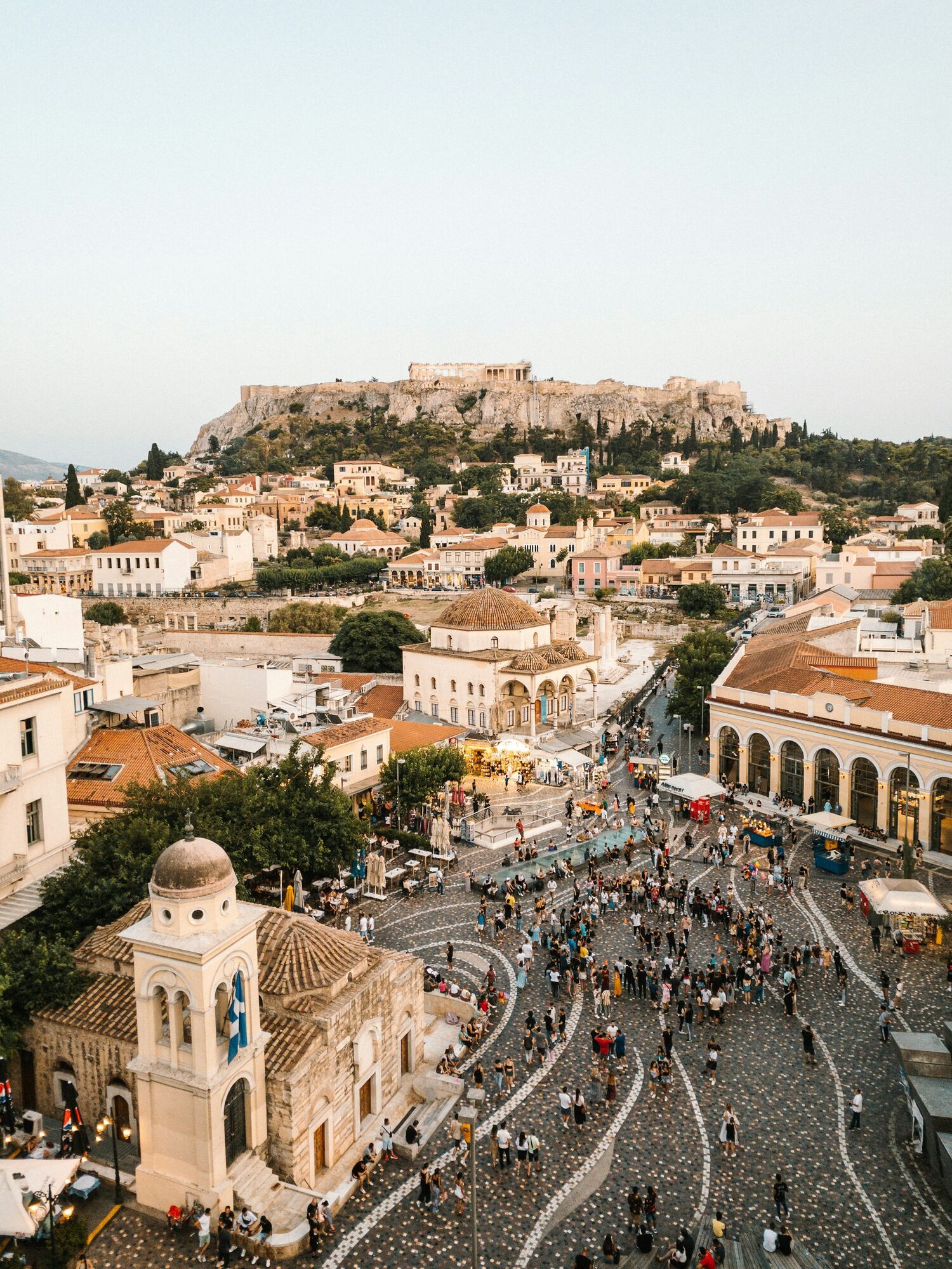 Crowded Monastiraki square with Acropolis in the background