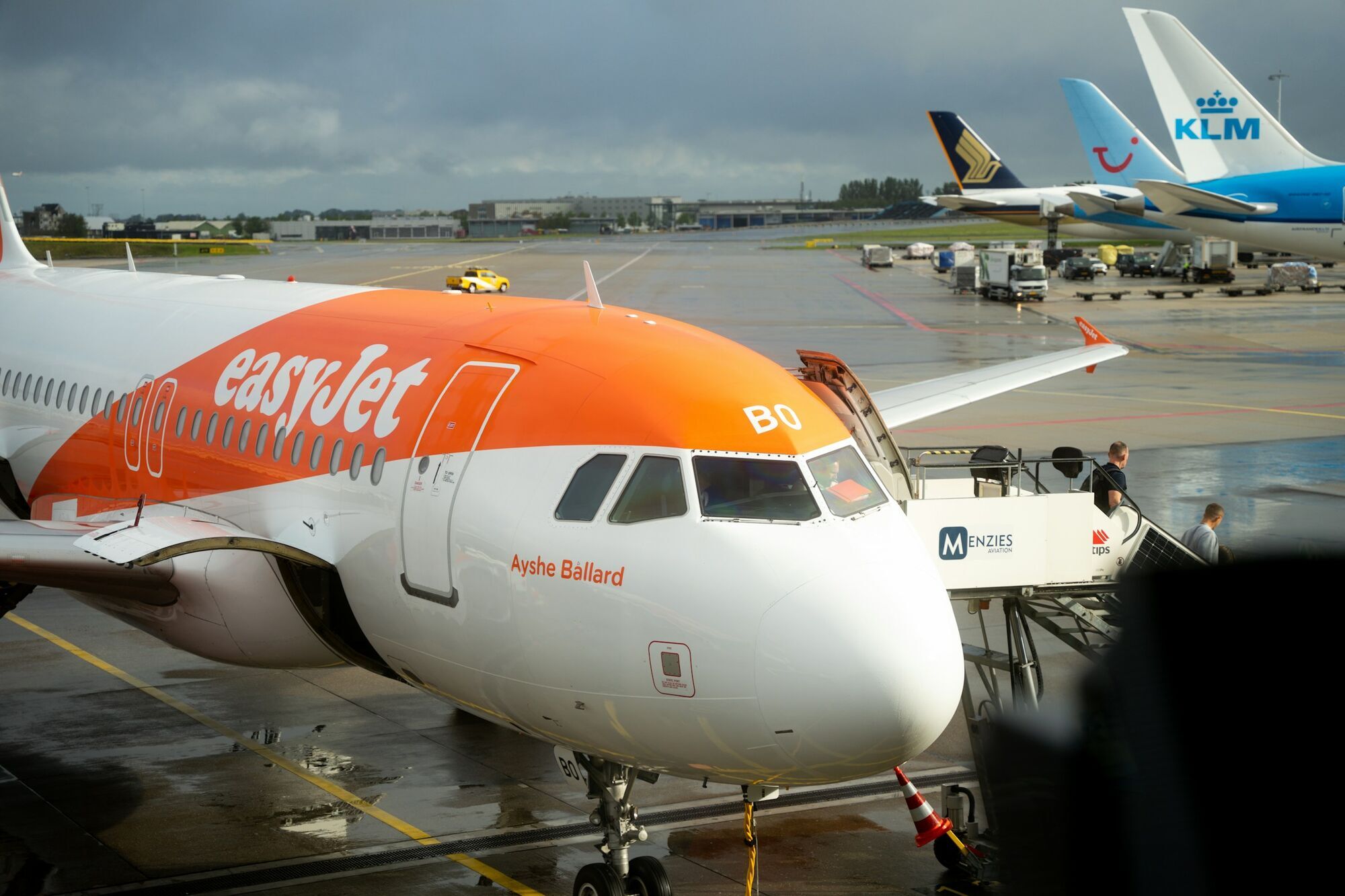 easyJet aircraft parked at airport gate during boarding
