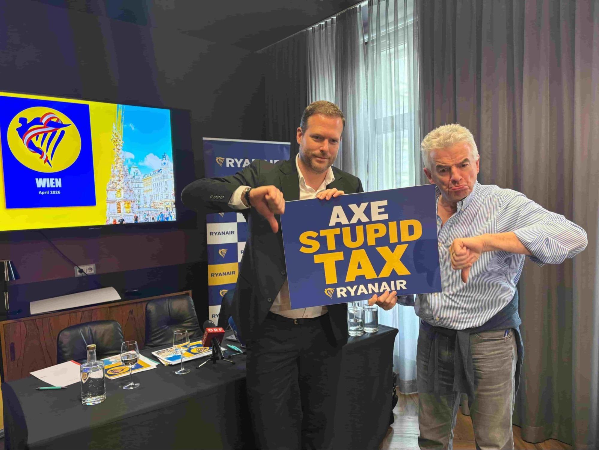 Ryanair executives holding sign calling to remove aviation tax in Vienna