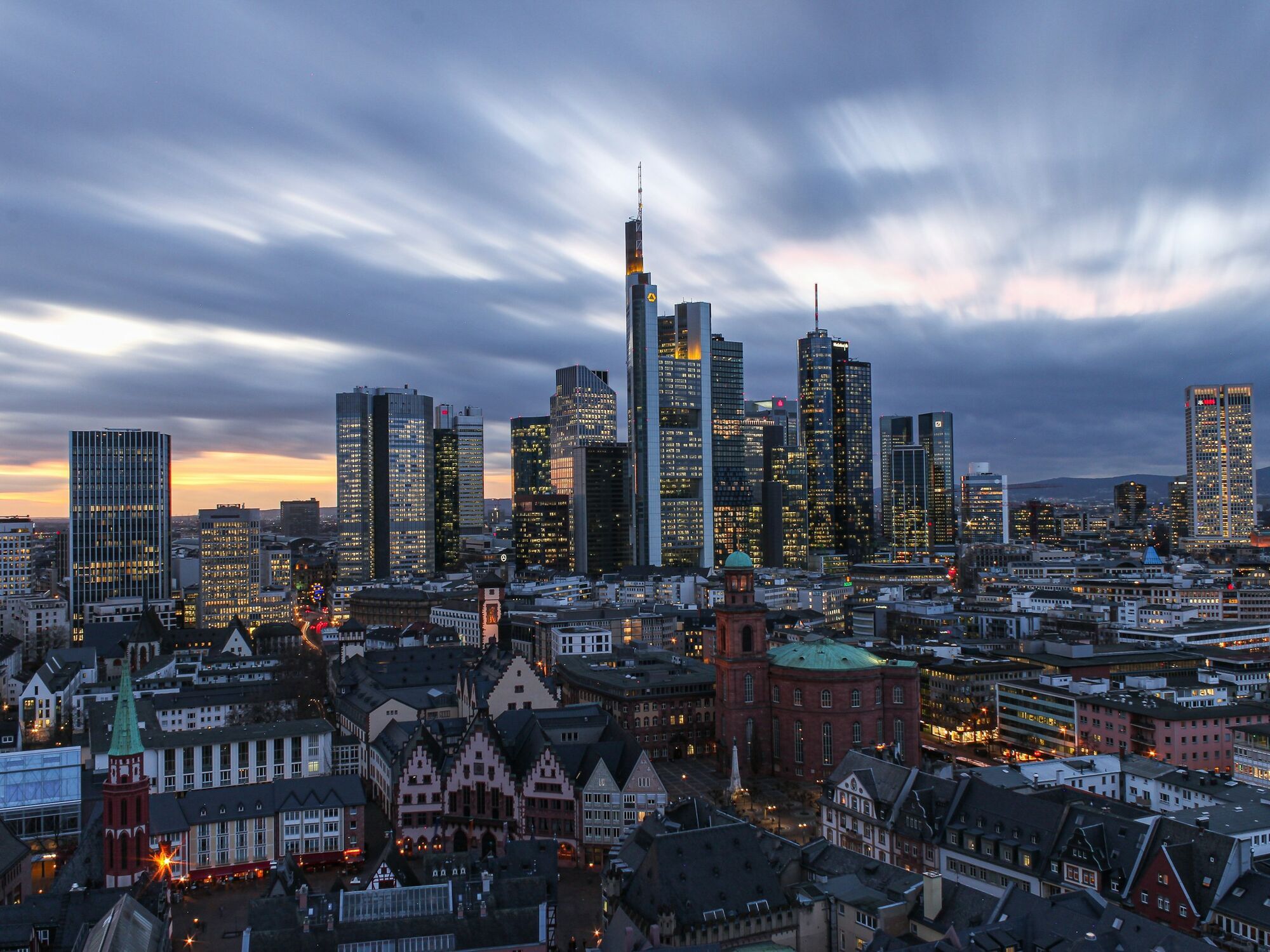 Frankfurt city skyline at dusk with illuminated financial district towers