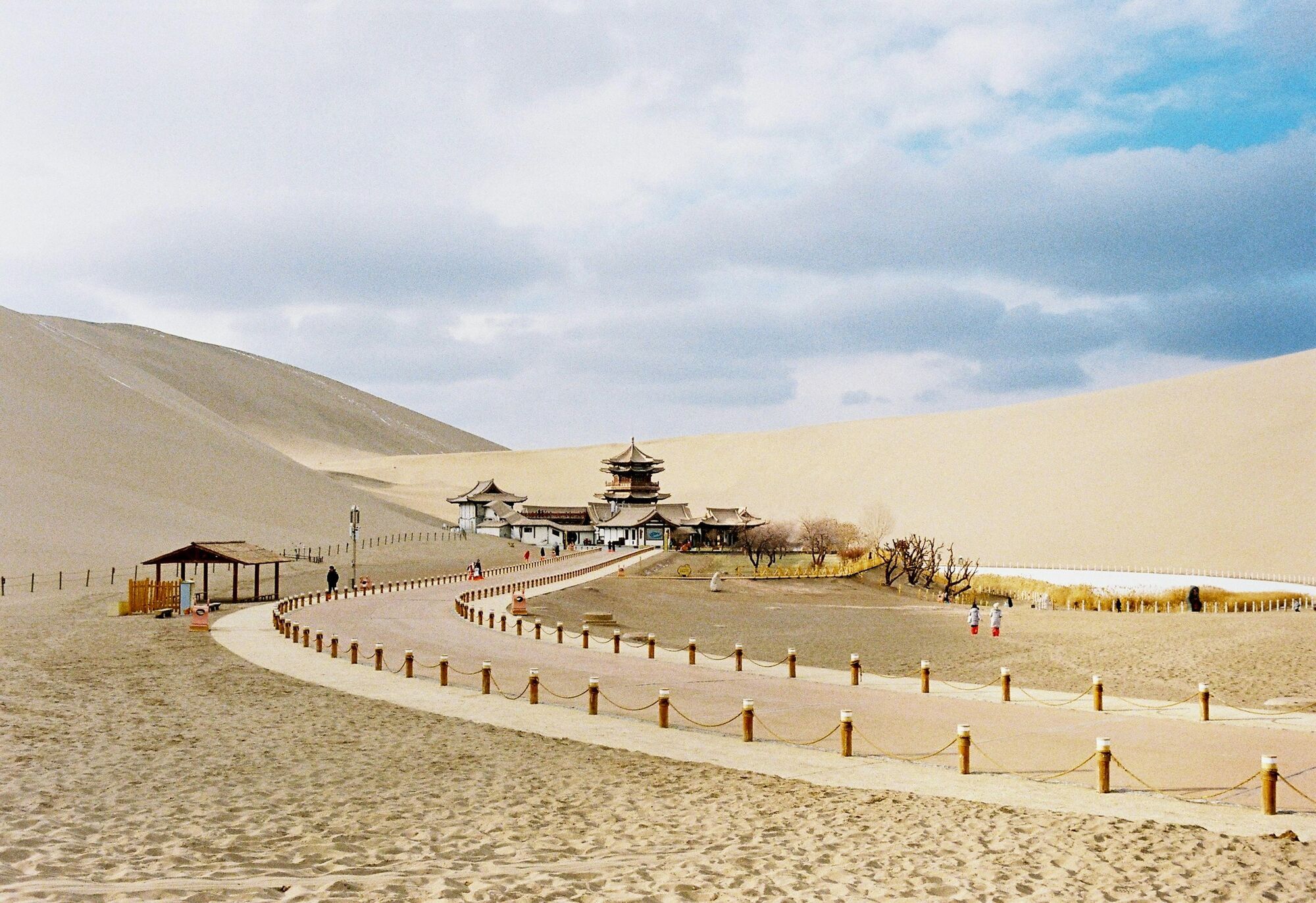 Ancient Silk Road desert landscape with dunes and traditional buildings