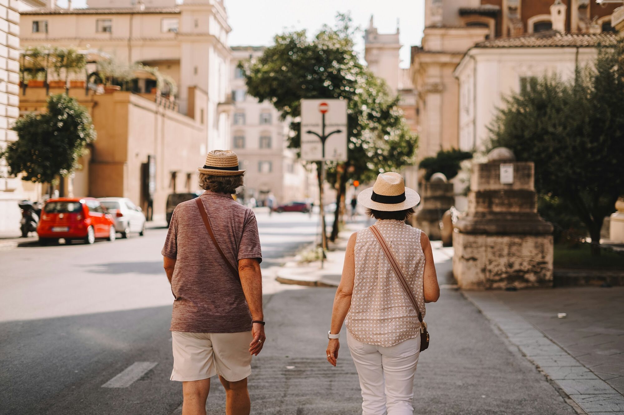 Older couple walking along a city street during a trip in Europe