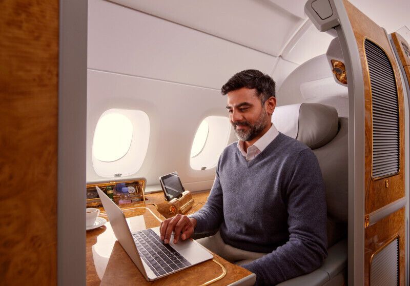 Passenger using laptop in Emirates A380 cabin