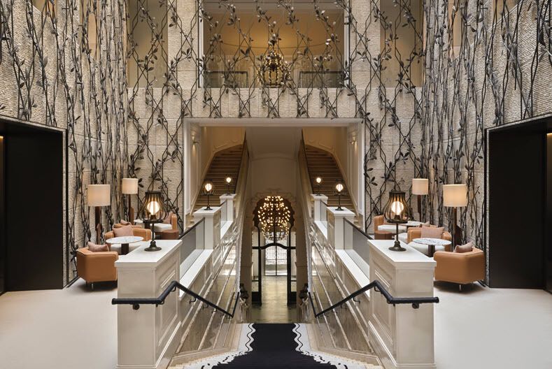 Interior of The St. Regis Budapest featuring restored architectural details and central staircase