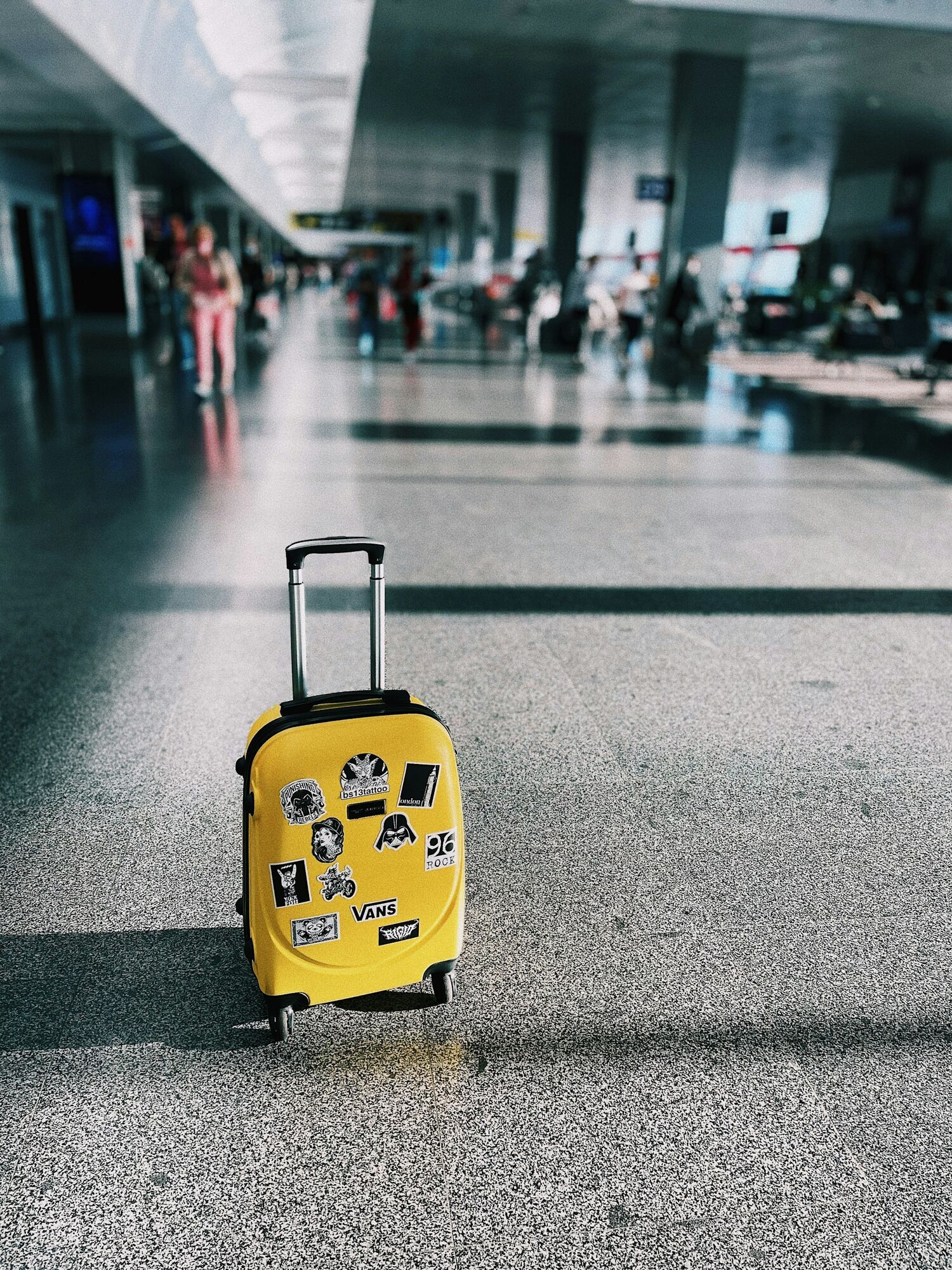 Small suitcase in airport terminal departure hall
