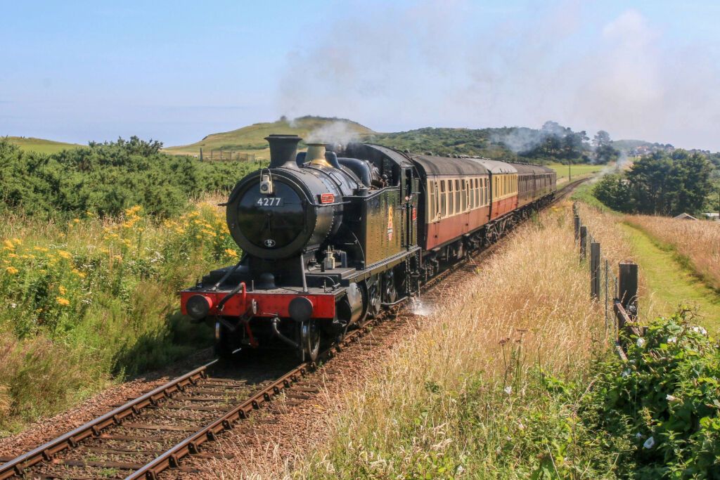 Heritage steam train travelling through Norfolk countryside