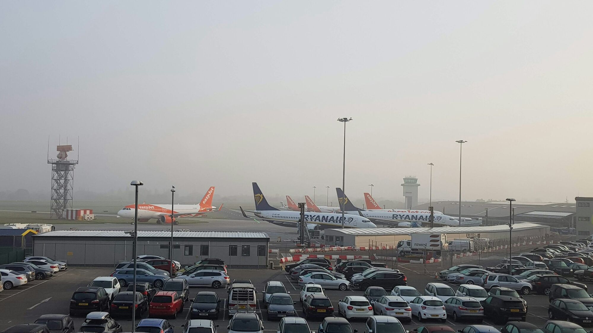 Cars parked near airport runway