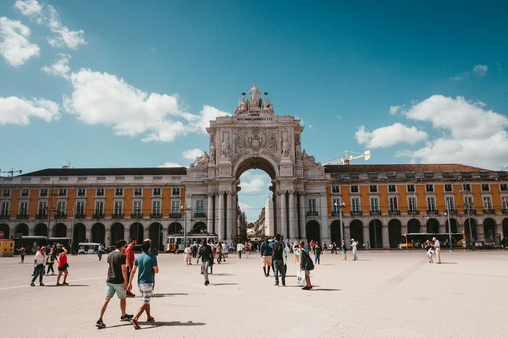 People walking near Rua Augusta Arch in Lisbon city centre